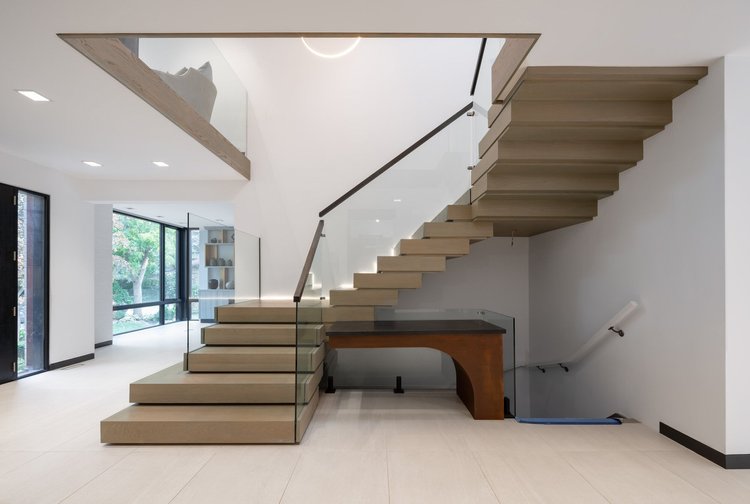 New open stair with a glass railing in a North York second storey addition by First Place Homes