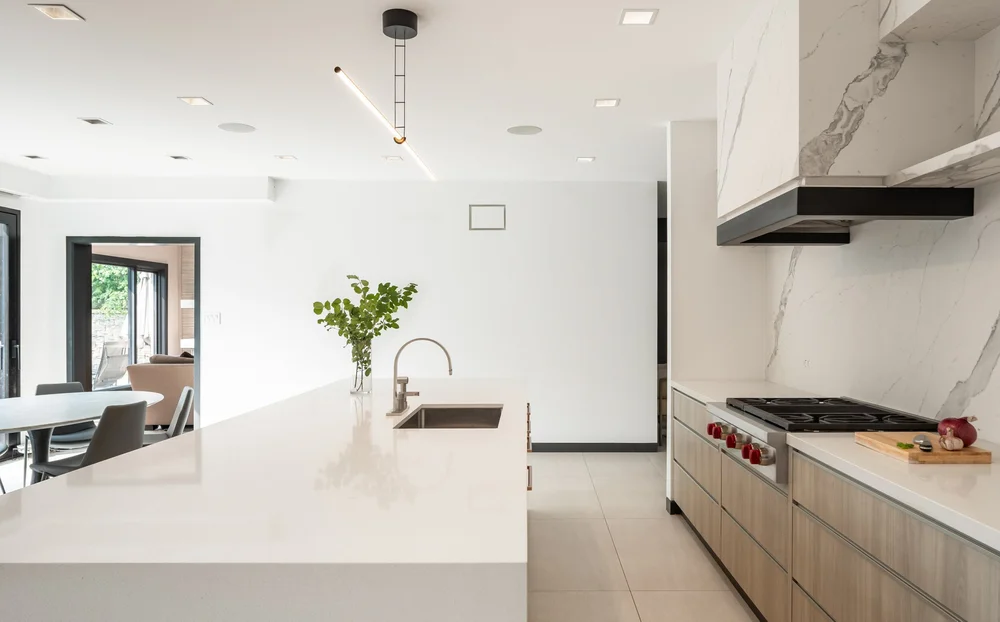 North York kitchen renovation by First Place Homes: island, marble hood and oak cabinetry