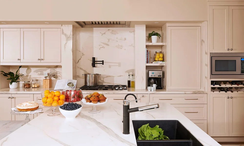 Toronto home addition kitchen by First Place Homes: white cabinets, marble backsplash and a black faucet