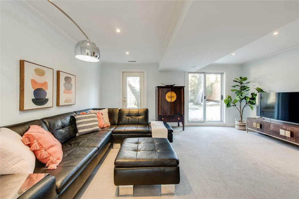 Lower-level family room with a walkout door in a North Central Toronto home renovation by First Place Homes