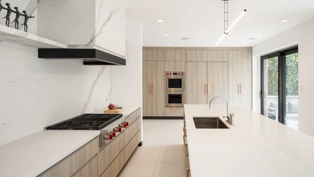 North York second storey addition kitchen by First Place Homes: marble range wall and pale oak cabinetry