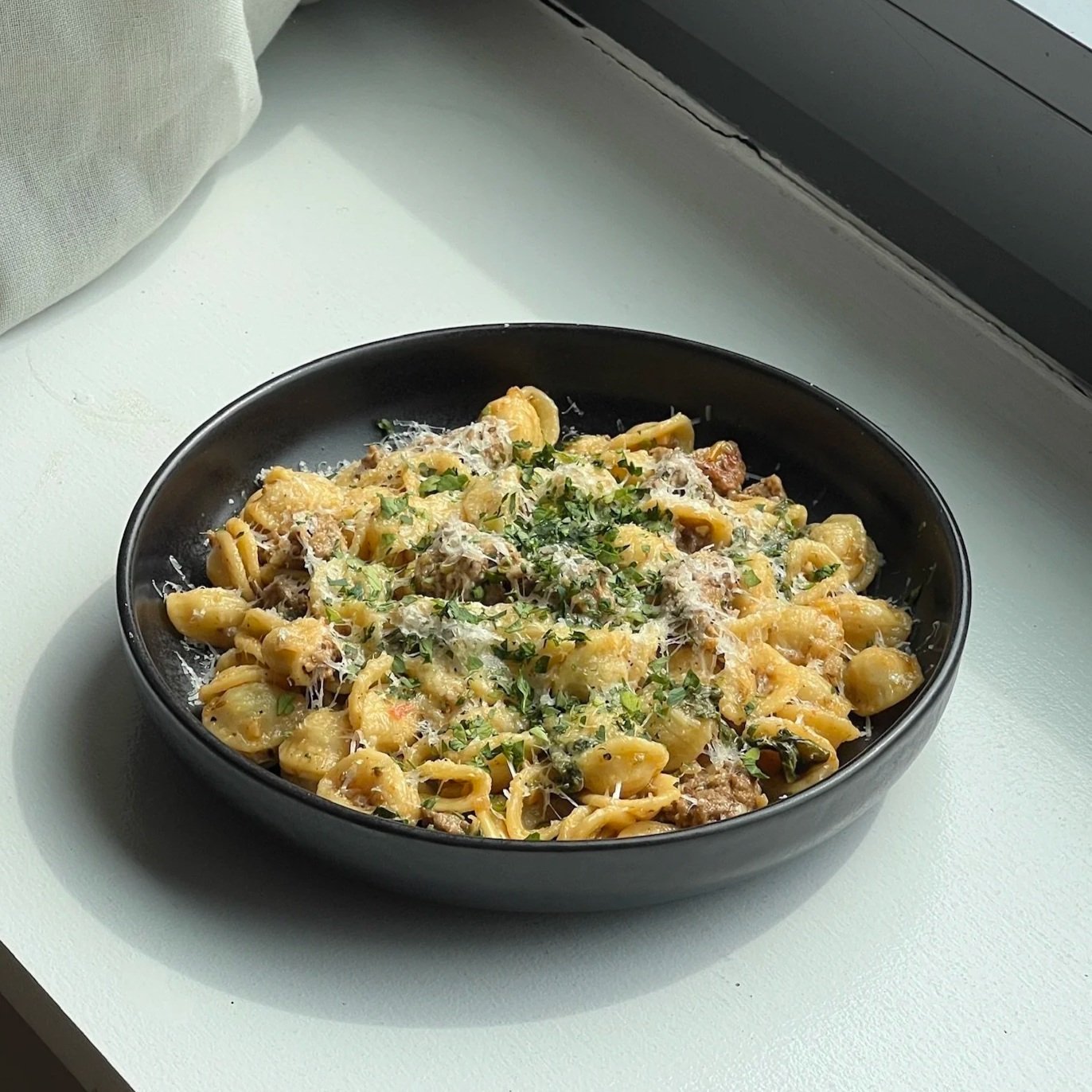 A bowl of lamb and swiss chard pasta