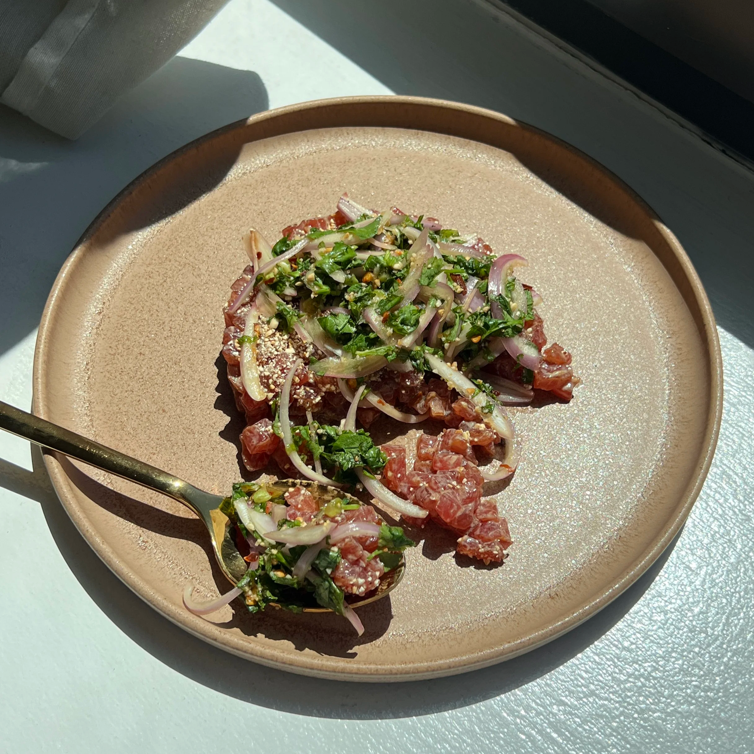 Tuna tartare on a plate with Thai larb topping