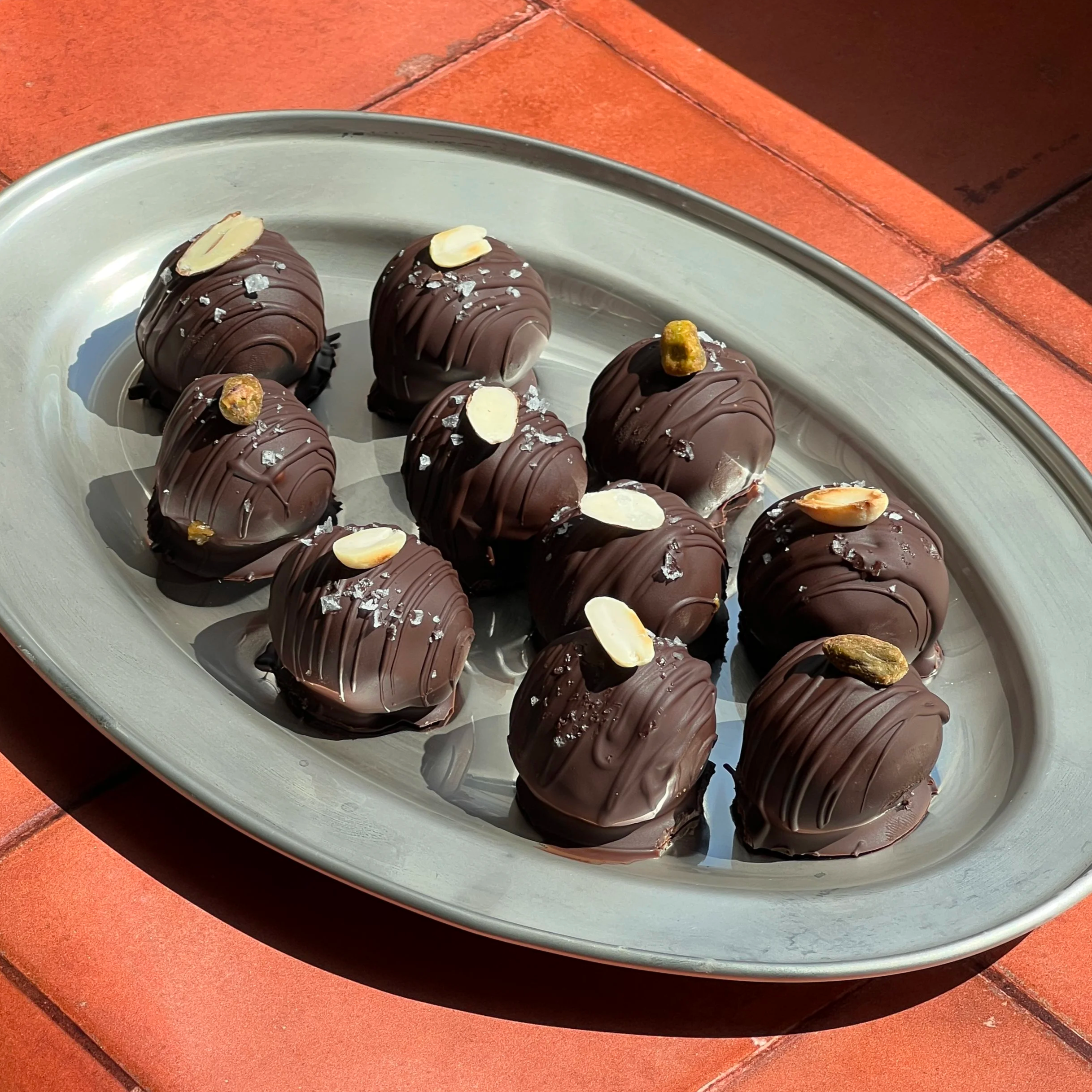 chocolate date truffles on a silver plate