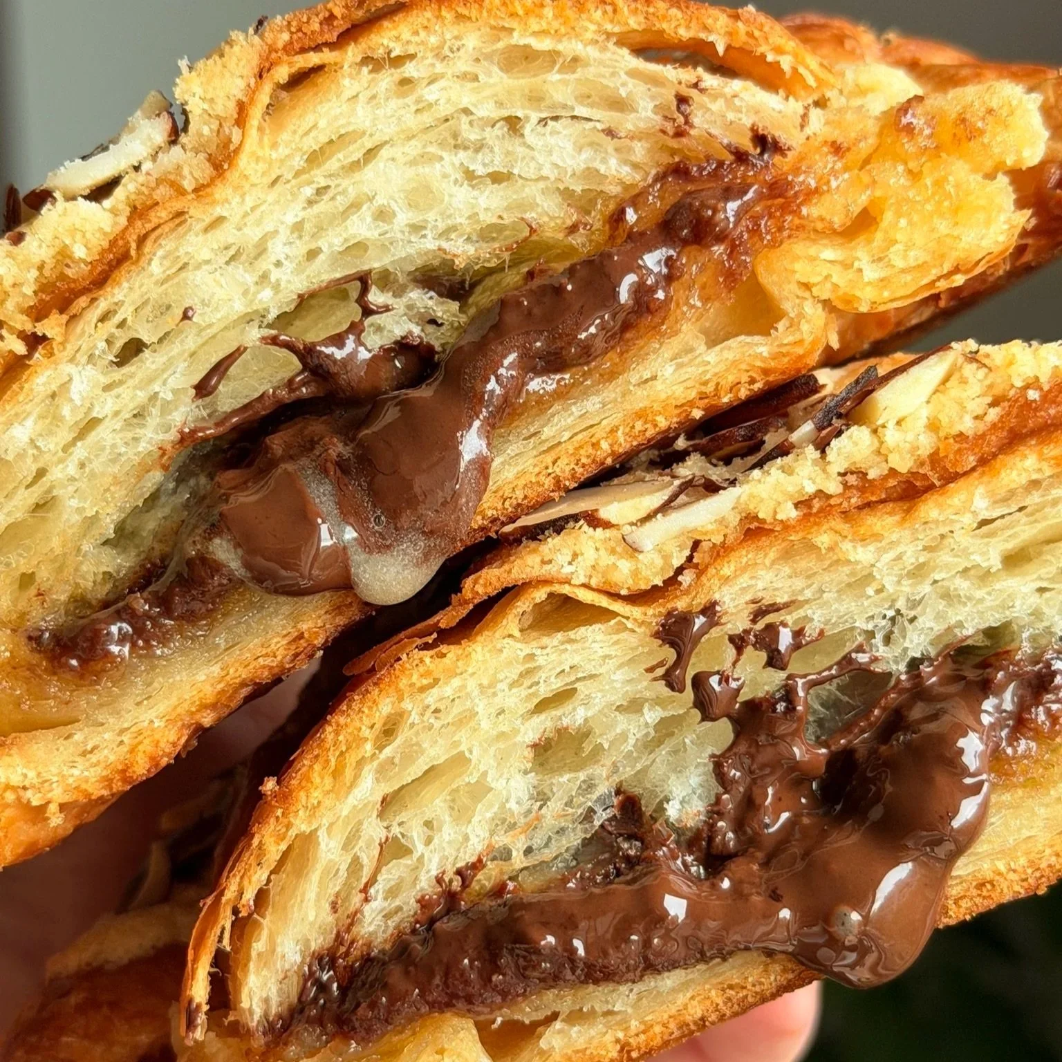 Chocolate almond croissant cut in half, with chocolate oozing out