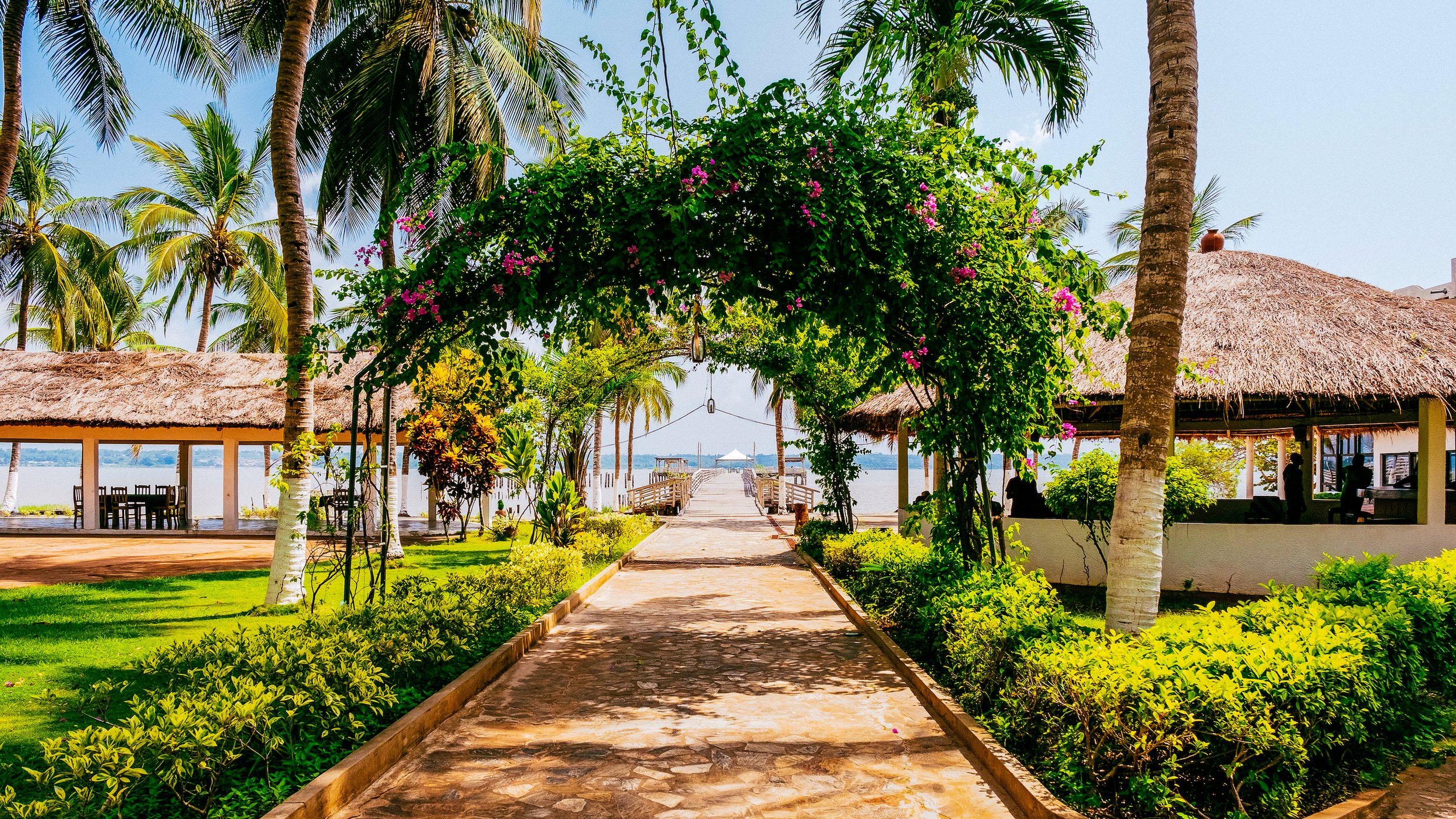 A beautiful archway with flowering vines growing across it in Possotome, Benin on Lake Aheme in West Africa. (Copy)