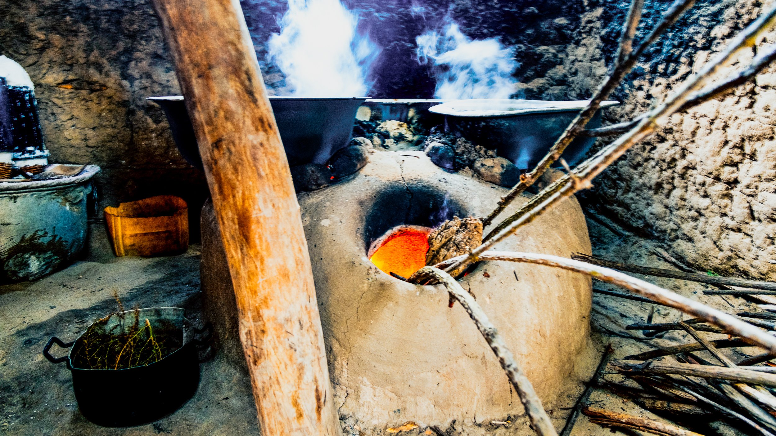 A generations-old earthen wood-burning stove boiling water which will eventually evaporate and leave salt behind. (Copy)