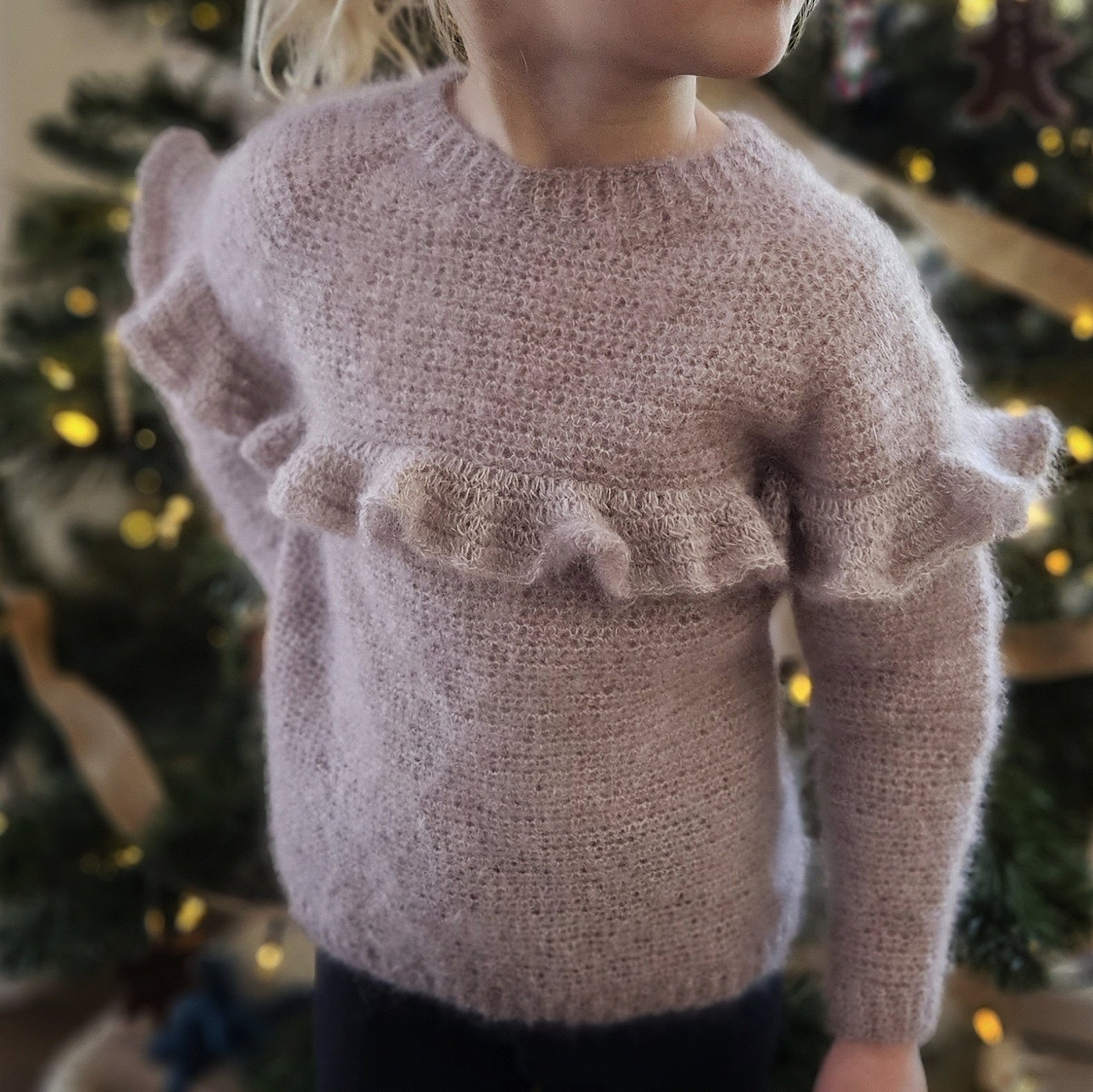 Purple raglan sweater adorned with playful ruffle accents