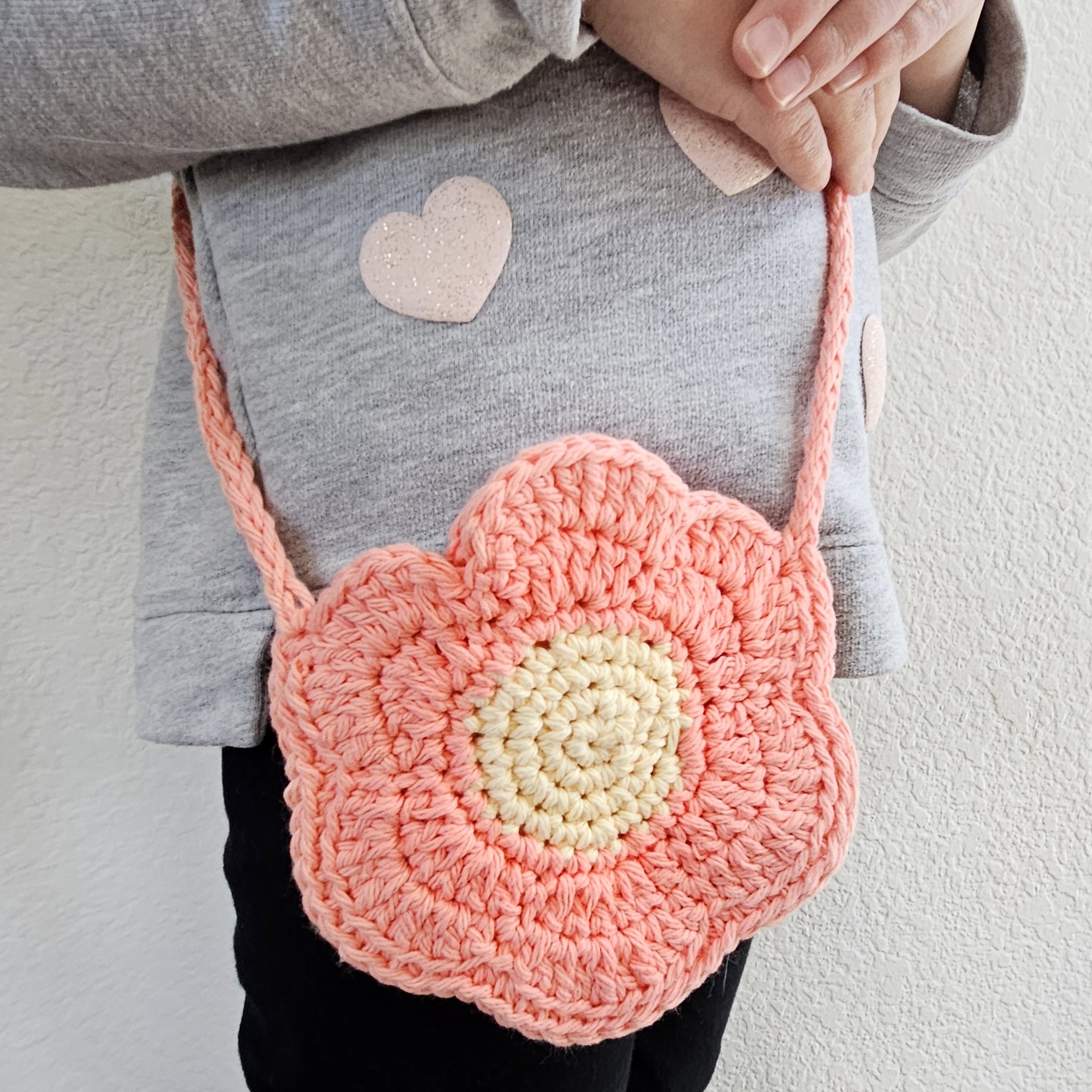 A hand-crocheted kid's flower purse for play or dress-up
