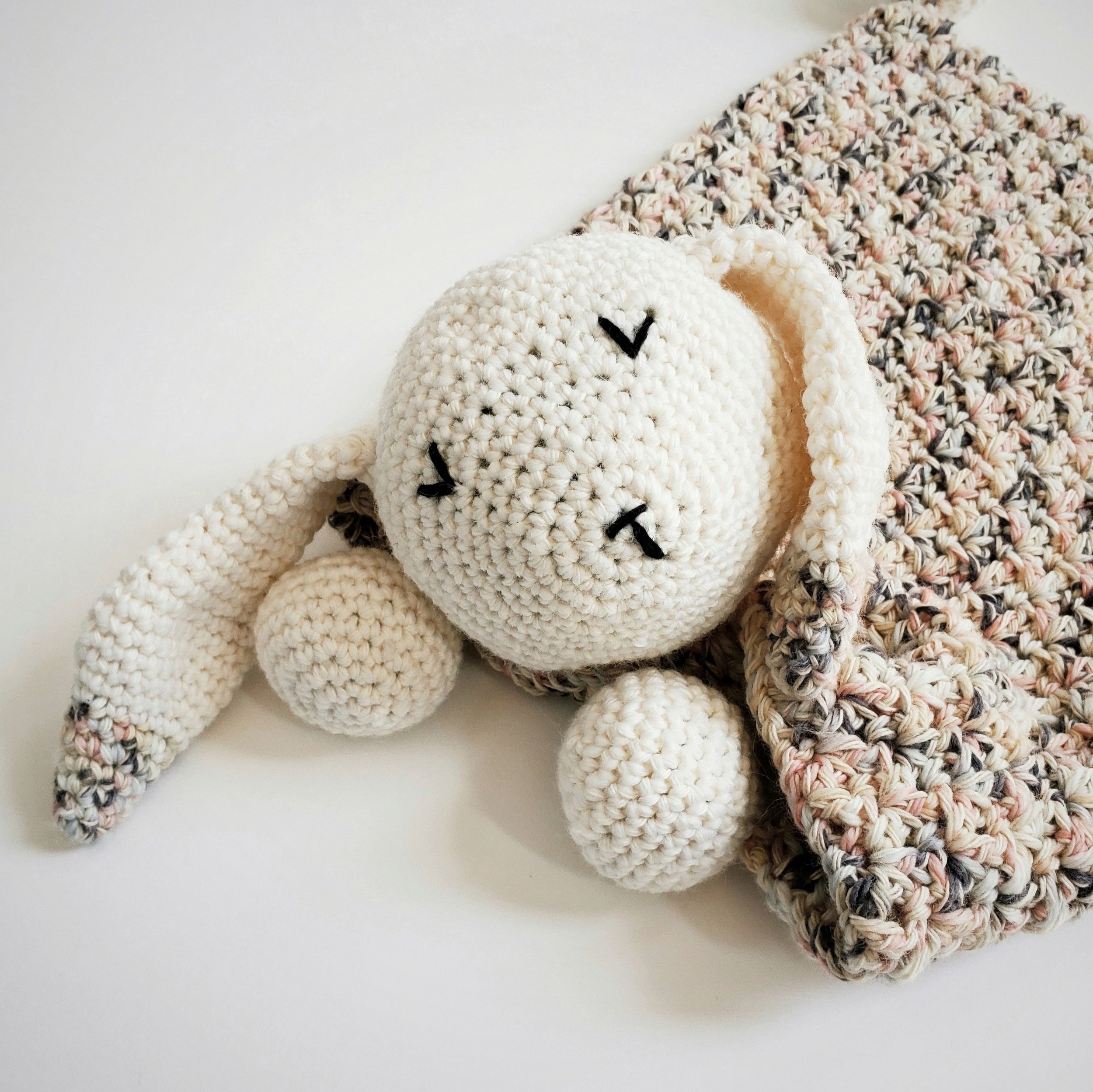 Crochet bunny lovey with a soft shell stitch blanket and sleeping bunny face, perfect handmade Easter baby gift.