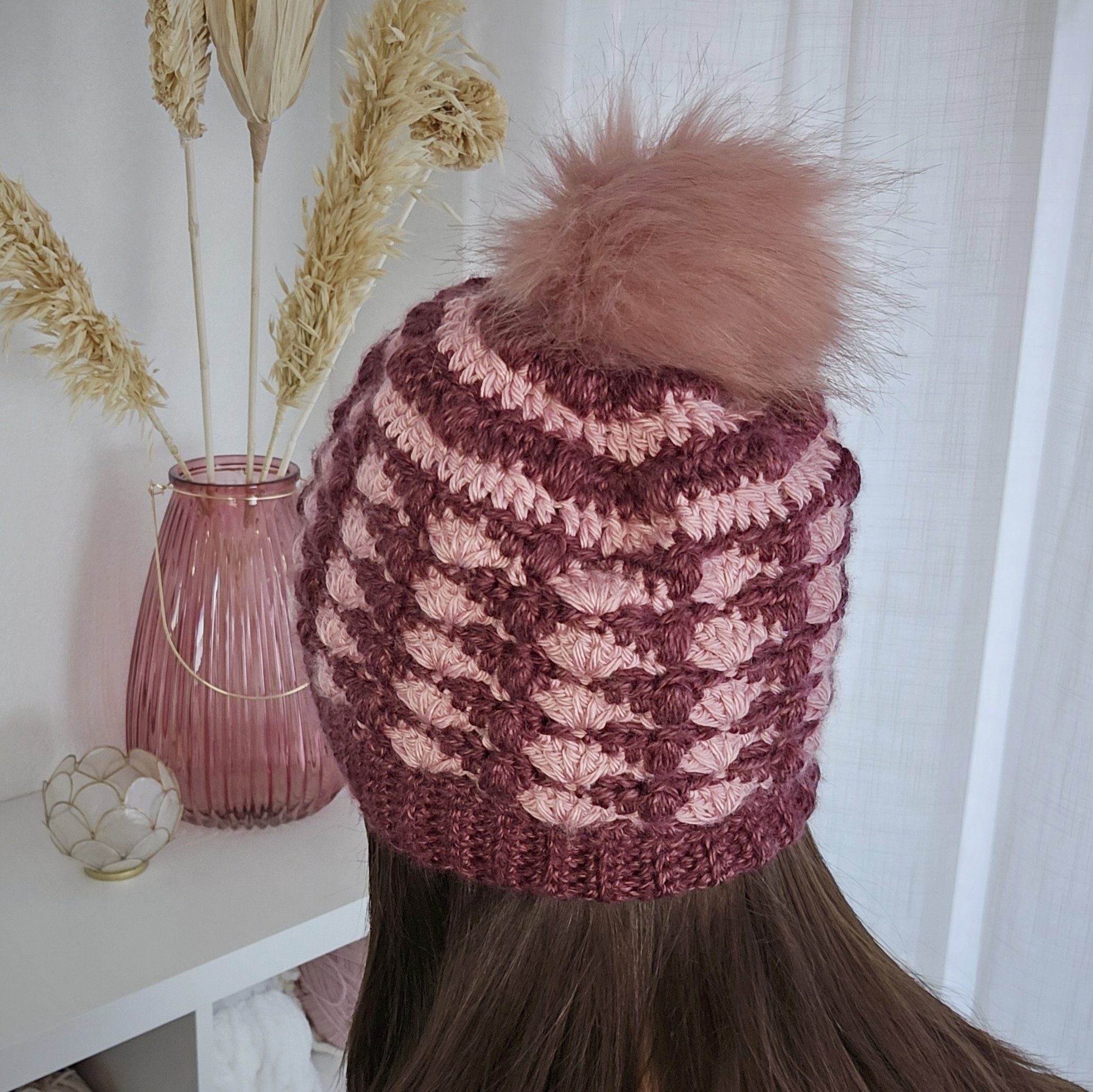 Close-up of the Granny Pop Beanie showcasing its vibrant, textured stitch pattern in multiple colors.