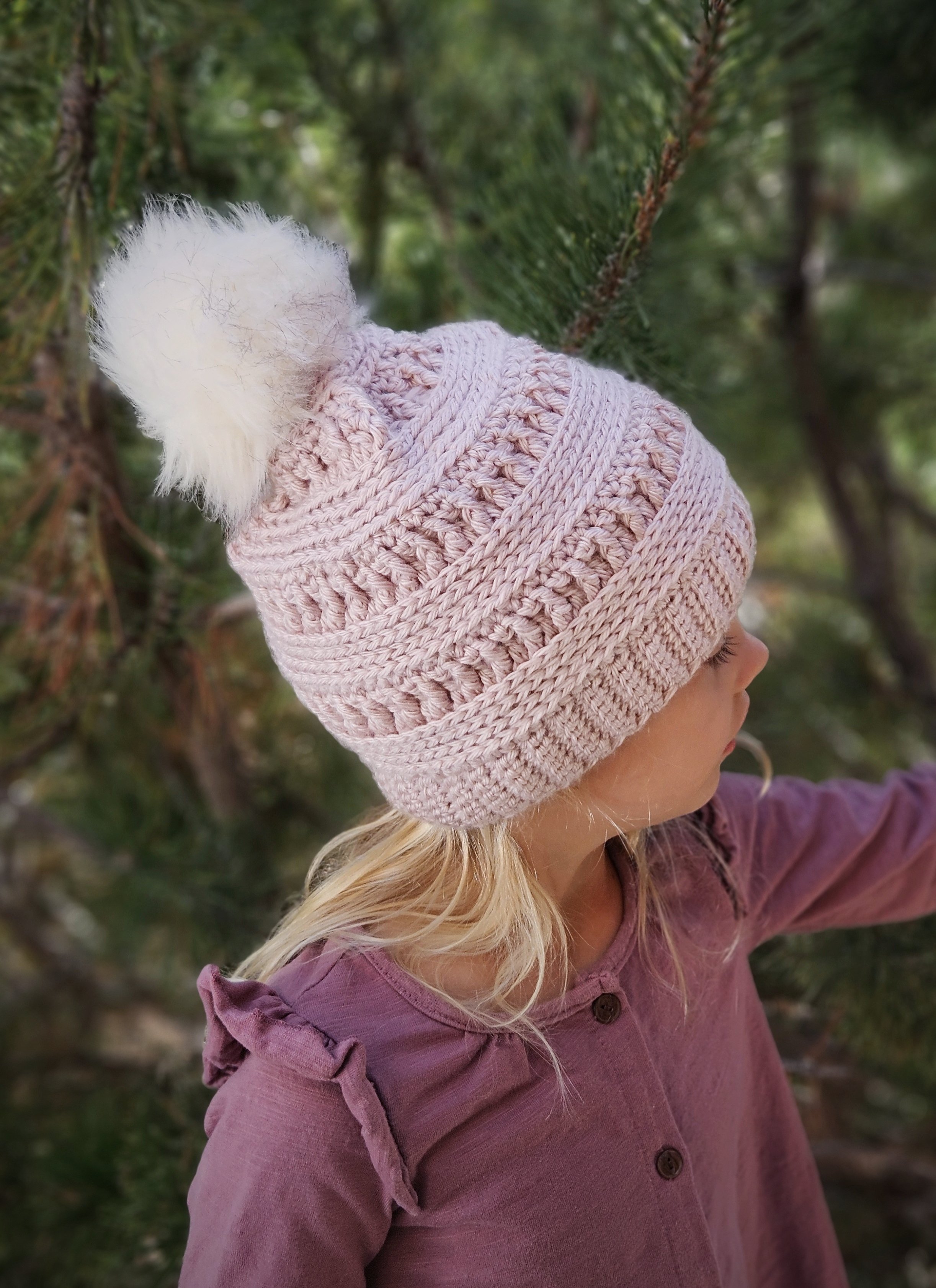 A hand-crocheted, slouchy, knit-look beanie pattern modeled by a girl