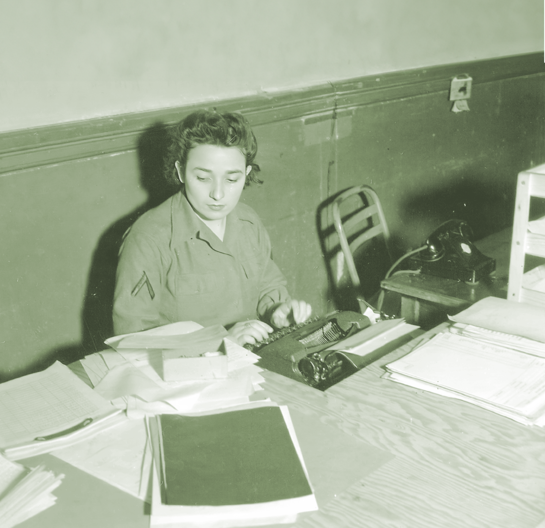 WWII office clerk typing at desk, Pureheart insurance article