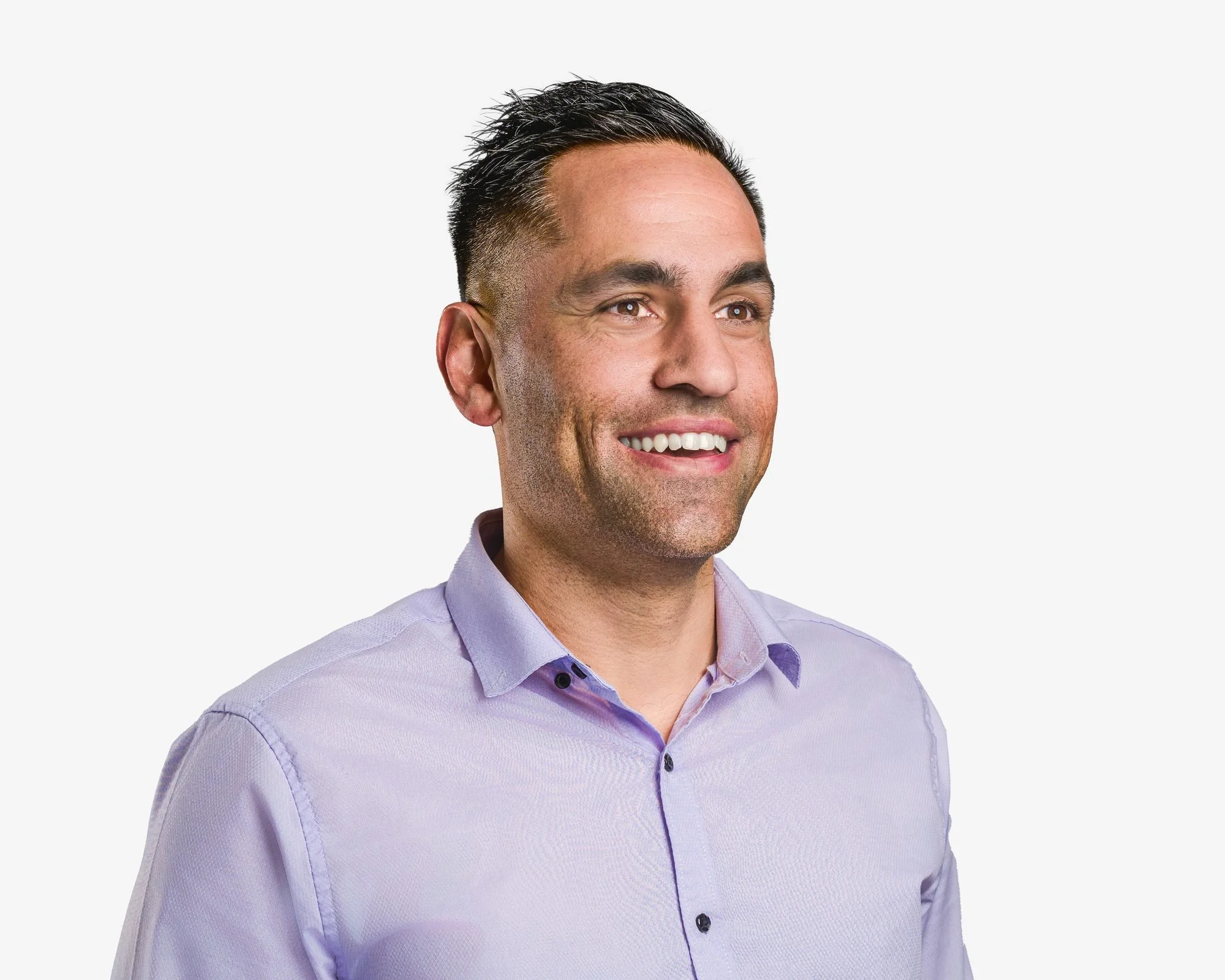 Corporate headshot of a man in a lavender shirt smiling to the side, Wollongong