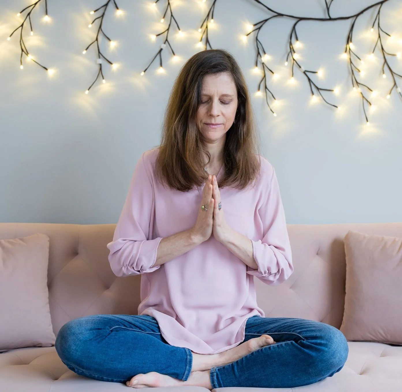 Sheila Fox Tam in a meditative pose, reflecting her yoga and mindfulness practice.