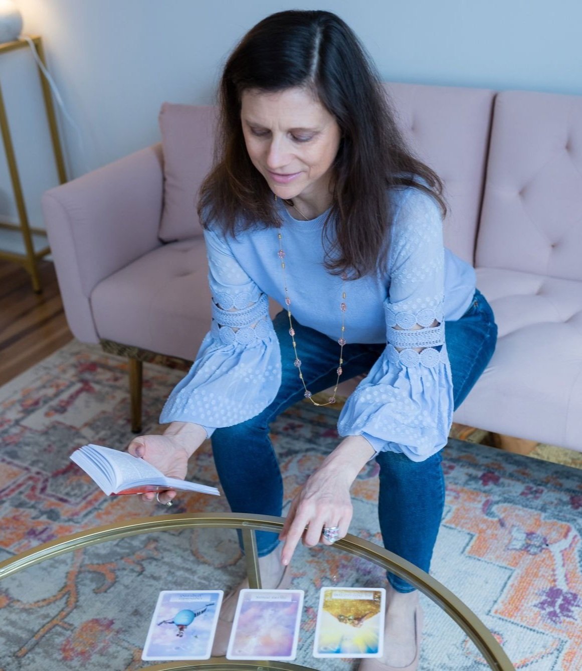 Sheila Fox Tam doing an intuitive card reading during an energy work session.