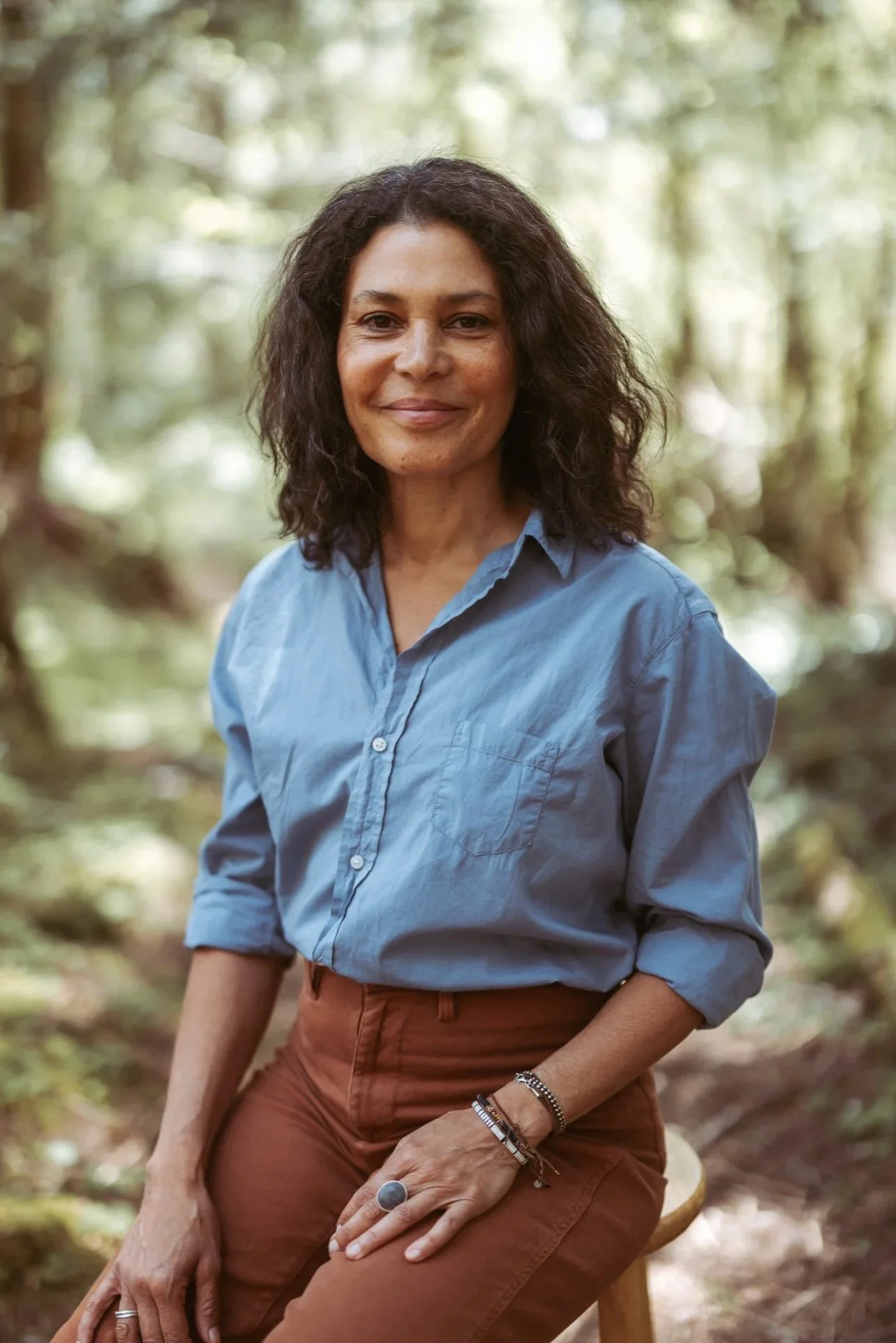 woman sitting in forest setting