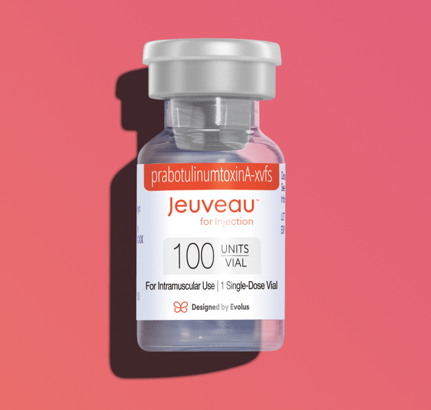 A medical vial labeled Jeuveau with 100 units, designed for injection, on a pink background.
