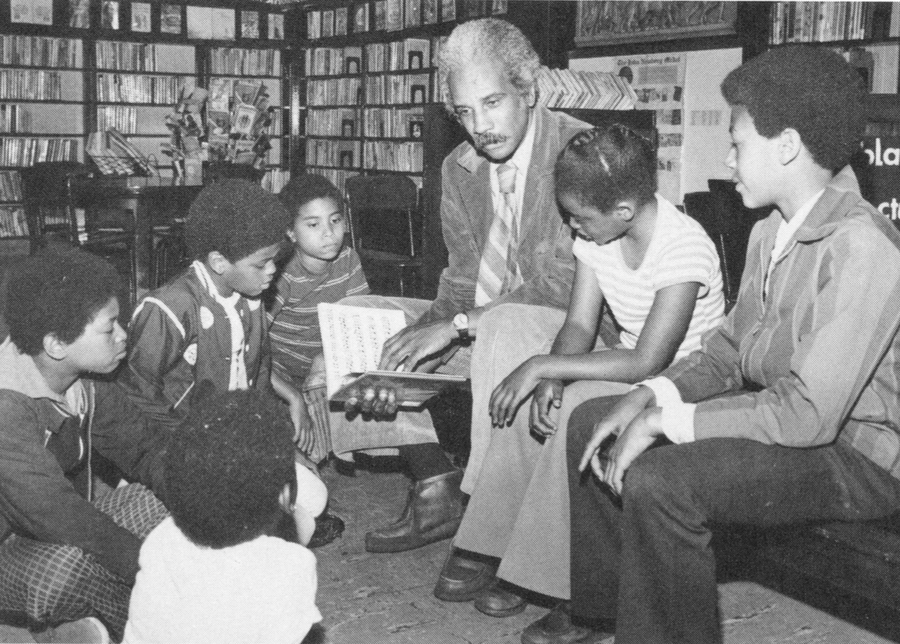 Ashley Bryan visits with local students before his reading with Robert Hayden, 1978