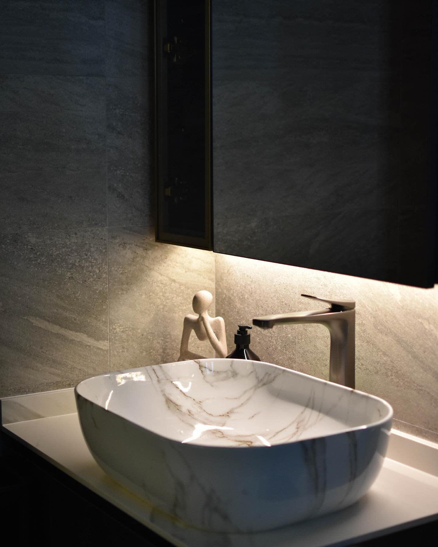 Pairing stone and marble finishes, you can further elevate your bathroom by incorporating ambient lighting and a small glass display area to showcase your perfume collection🔮