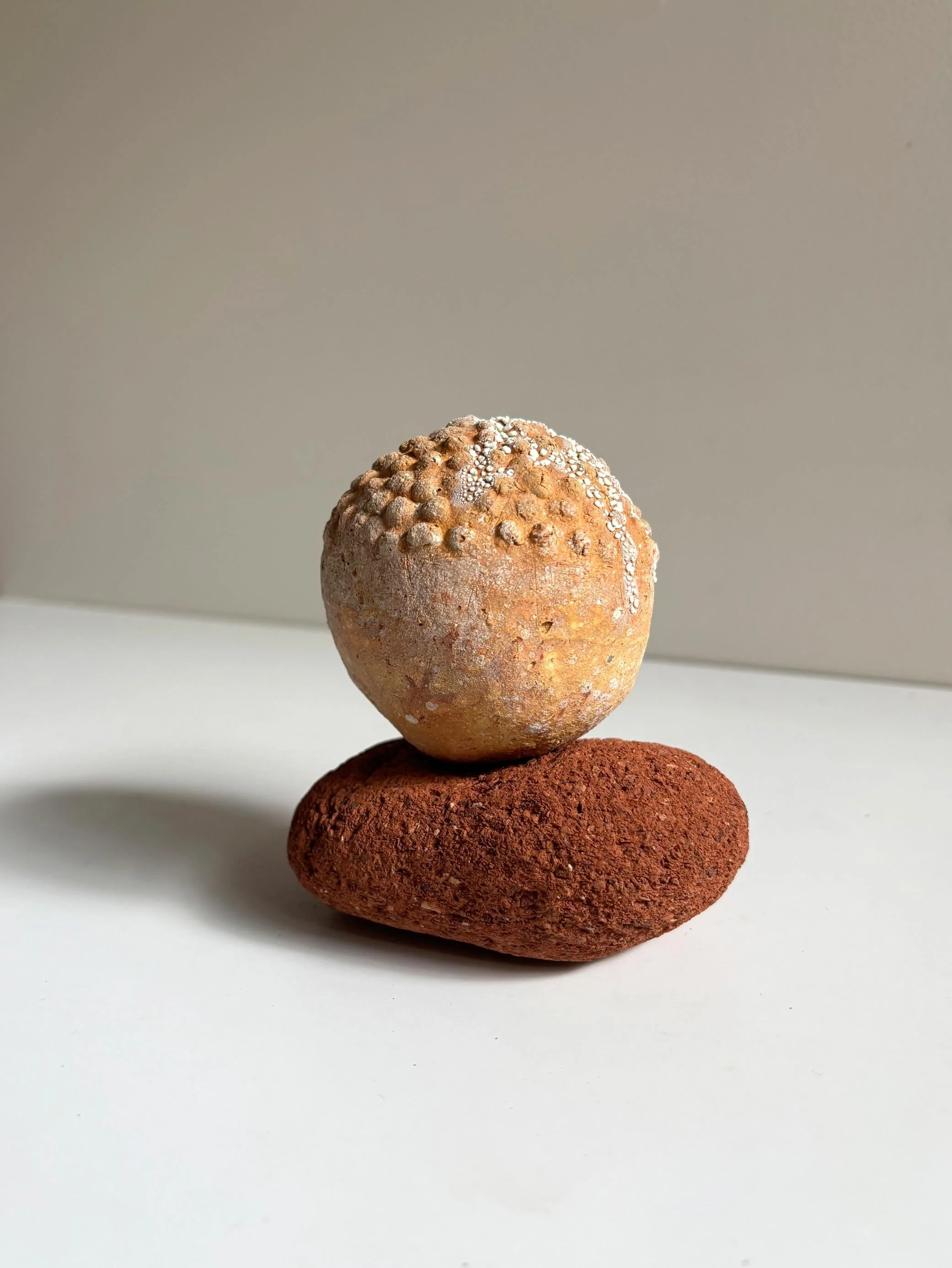 Mollusc Beacon is a story of place - the discarded brick element, picked up from and shaped by the sea is the cushion for a wild clay orb made by my hands.
As the land that borders the beach is made of clay the rough tides slowly dislodge chunks and 