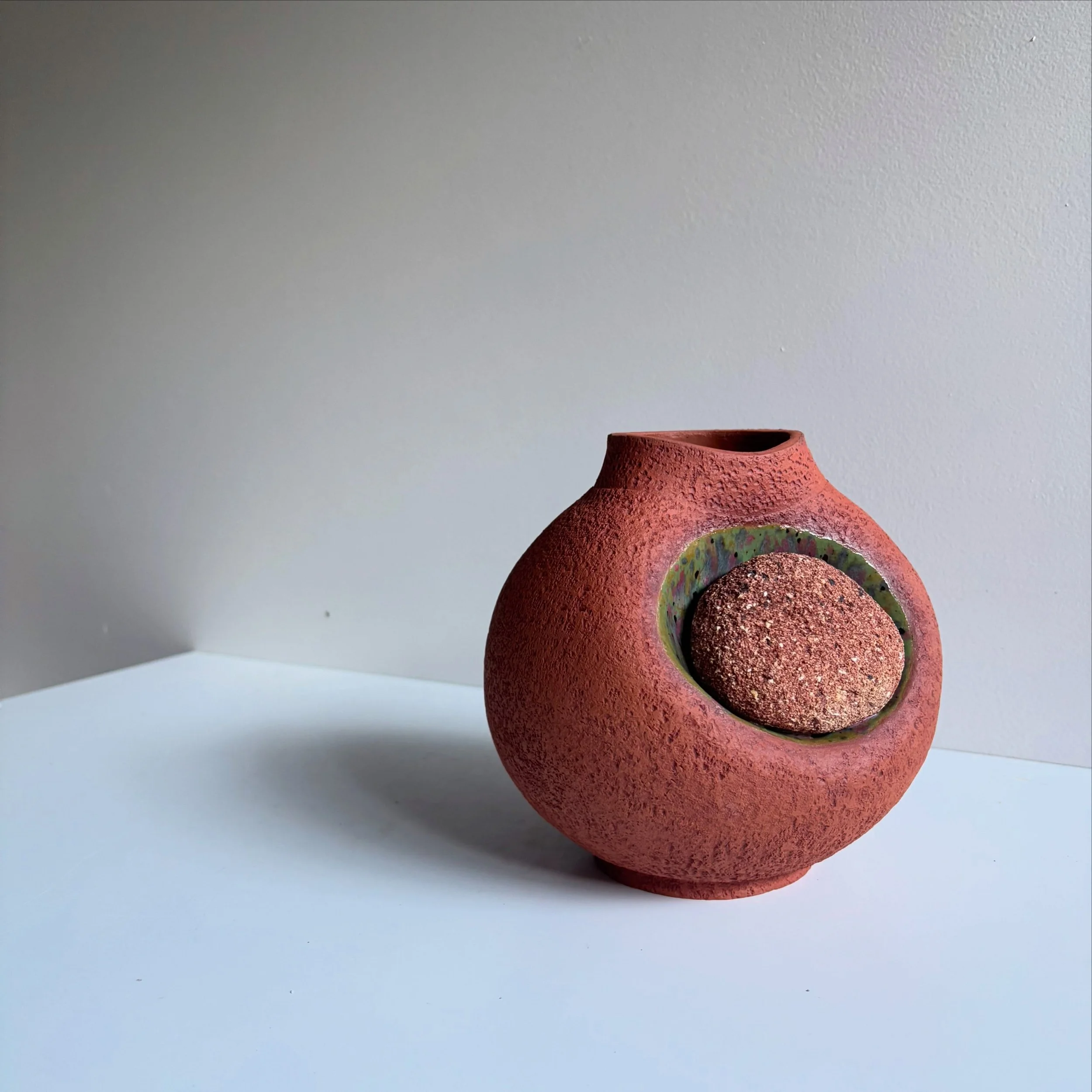 While waiting to show you images from my upcoming exhibition, here is something that I snuck into the kiln for fun! A brick stuck onto a vessel with glaze