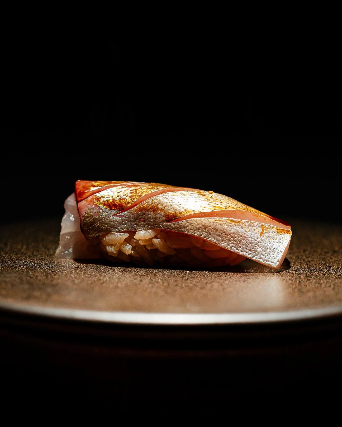 Shima Aji, Modern Style
Delicately balanced with our house-aged soy sauce, this Shima Aji reflects a modern approach to sushi&mdash;refined, precise, and rooted in tradition. Clean flavors meet umami depth in every bite.

#SushiLovers #OmakaseExperie