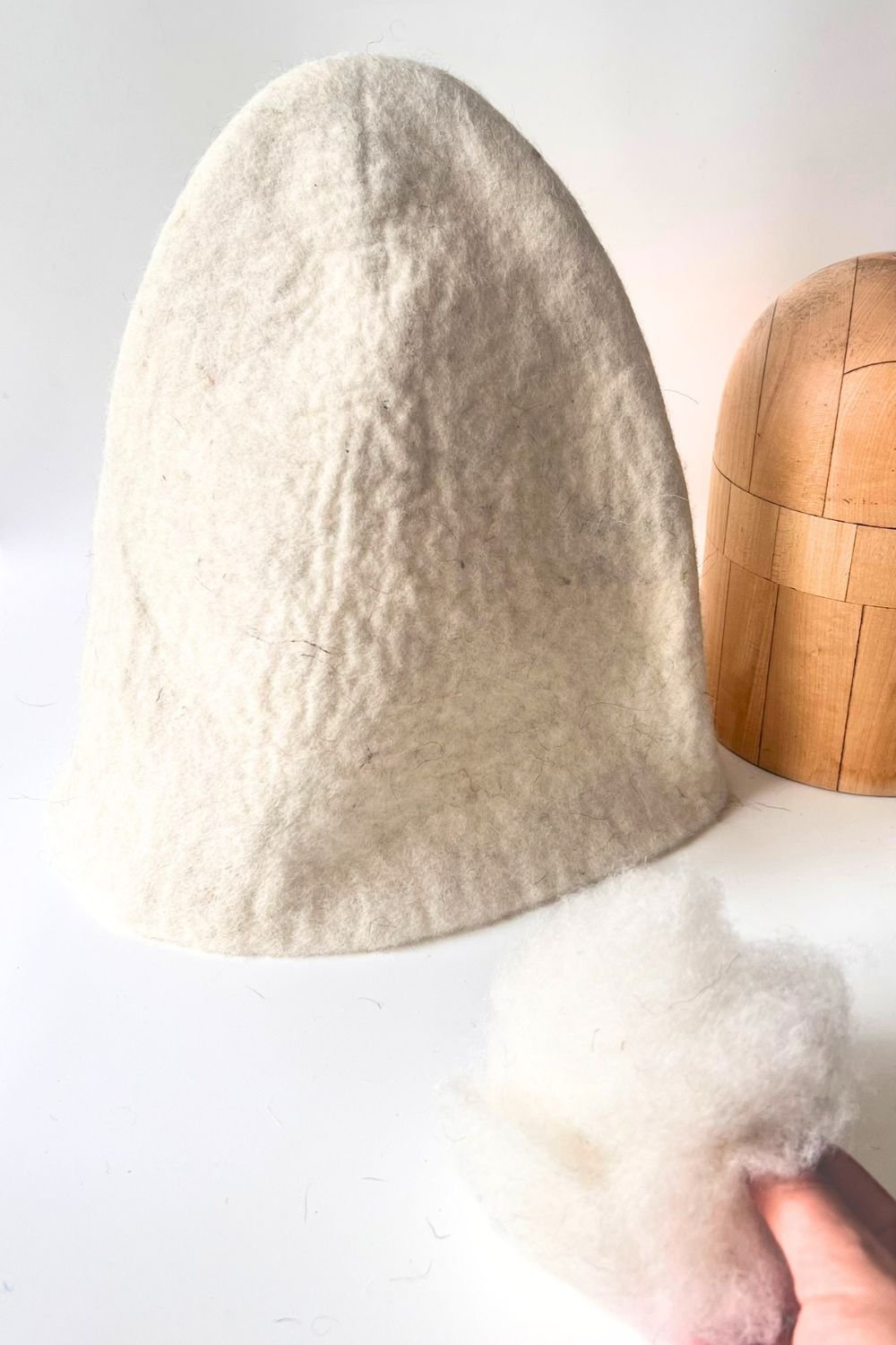 Wool sauna hat with the brim folded down over the eyes and ears