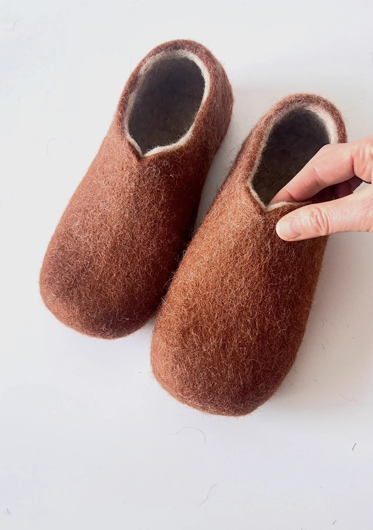 Feltforma handmade wool slippers in rust brown — regular fit, hand-sculpted to your bare foot measurements. Not a standard size chart. Custom proportions available for wide feet, bunions, and high instep