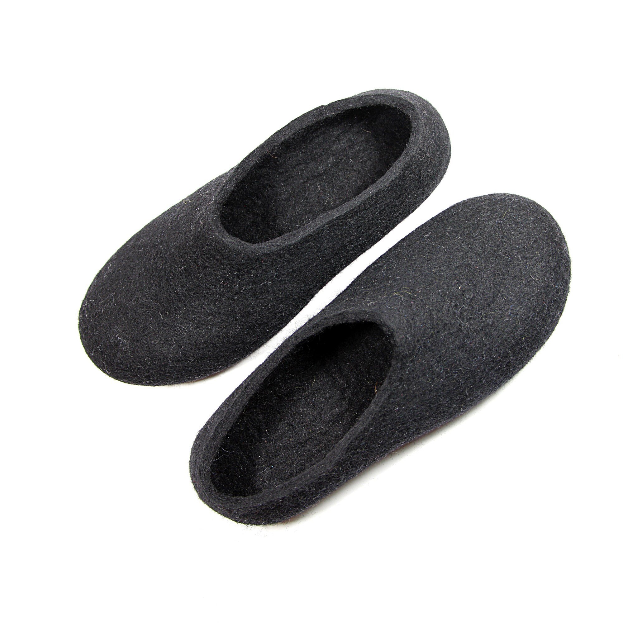 Handmade black wool slippers for women with soft felt soles. Organic, breathable, and perfect for slow mornings and grounding comfort.