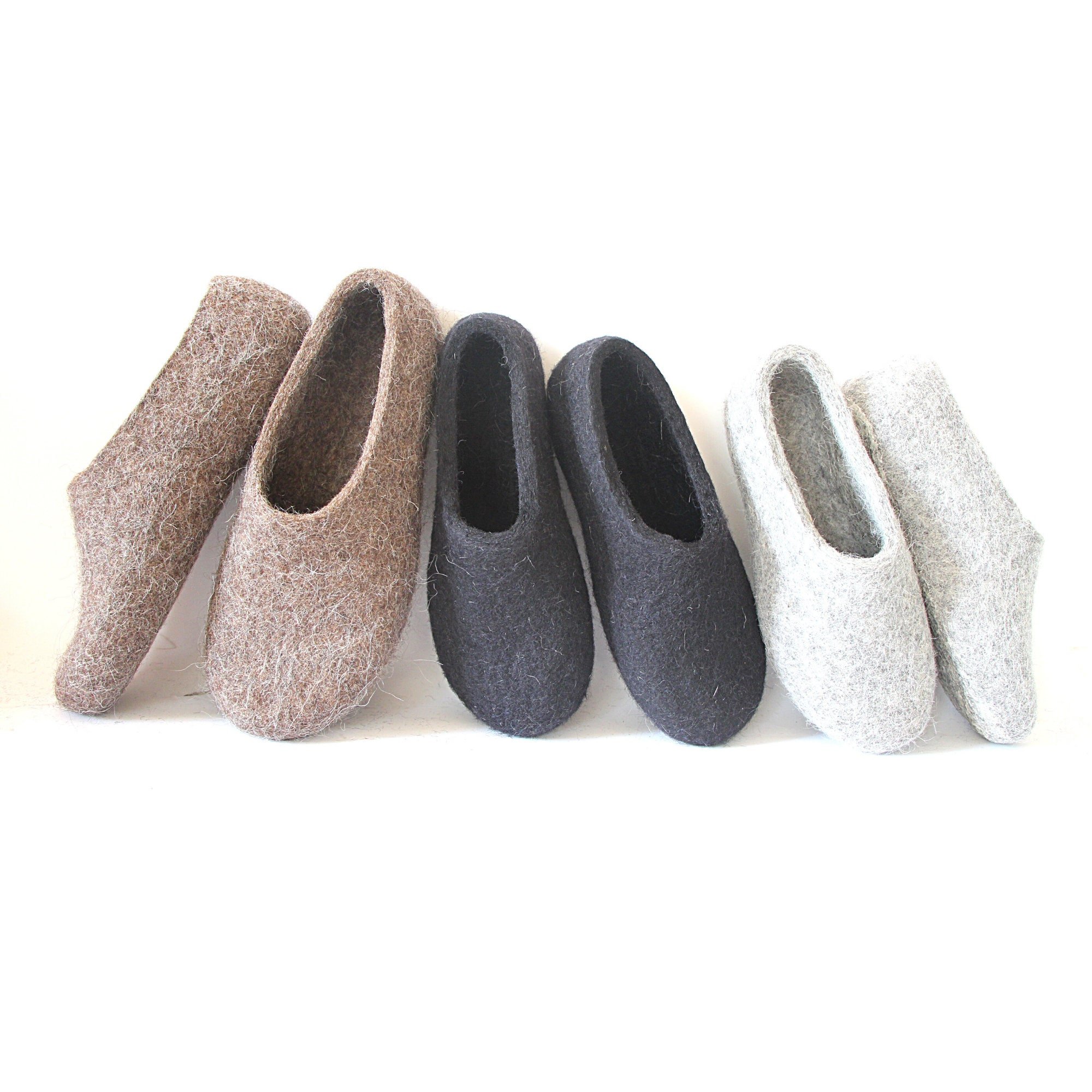 Black wool slippers with optional latex soles for grip on smooth floors. A quiet, cozy option for women seeking natural materials and warmth.