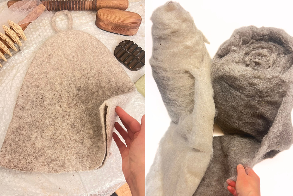 Light beige wool sauna hat on the felting table with wooden tools, beside rolls of raw carded Alpine wool in cream and gray