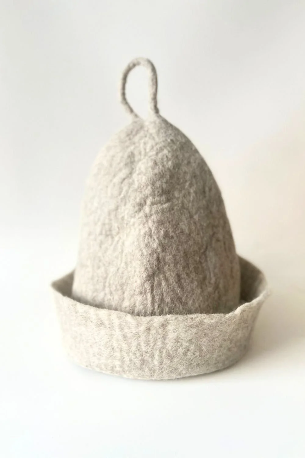 Feltforma undyed grey wool sauna hat hand-felted from mulesing-free Tyrolean mountain wool — water-washed only, no dyes, no chemical treatments, one size adjustable, made in Vilnius Lithuania, ships to the US duty-free