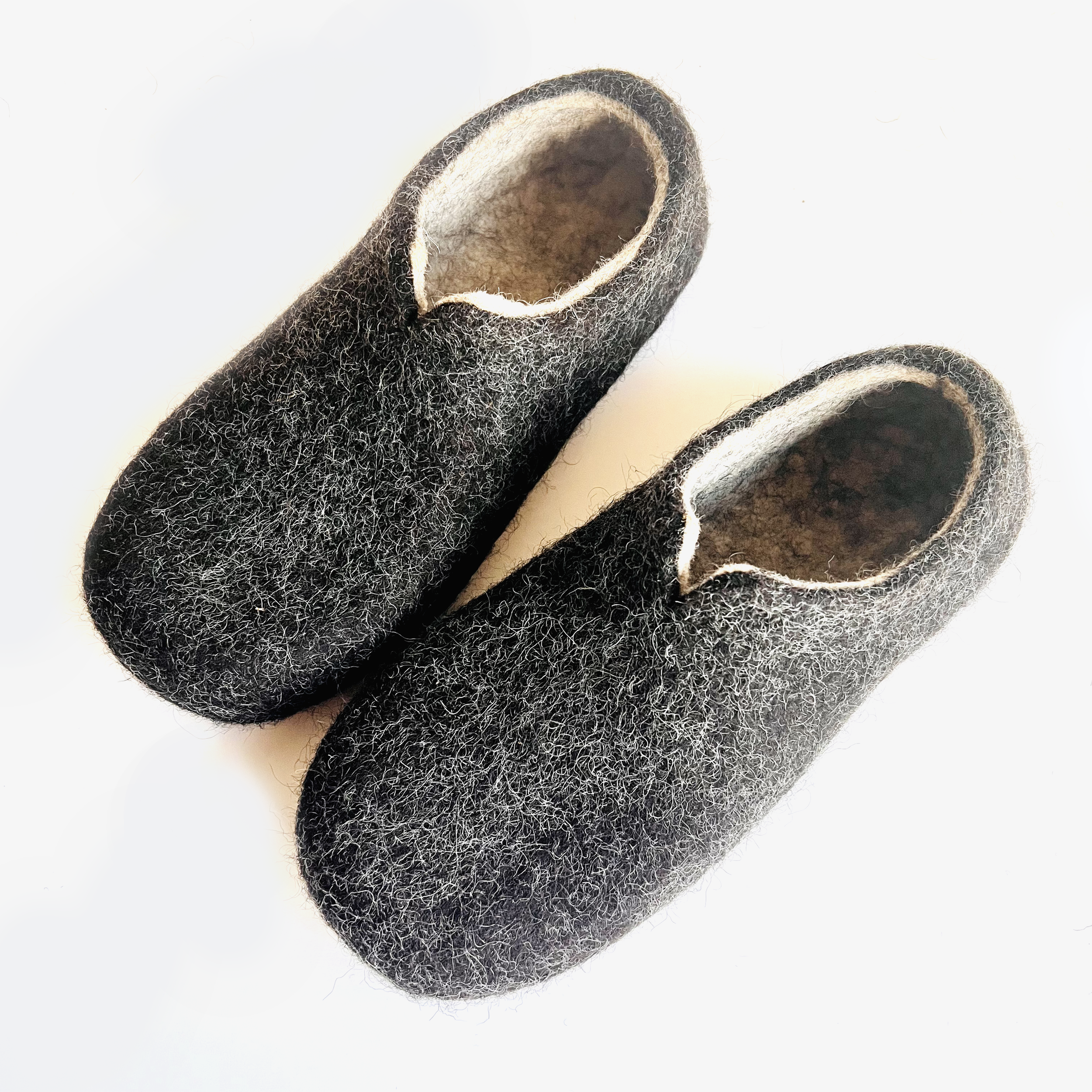 Handmade wide fit slippers in charcoal organic wool, designed for women who need custom sizing. These felt house shoes combine timeless European craft with eco-luxury comfort.