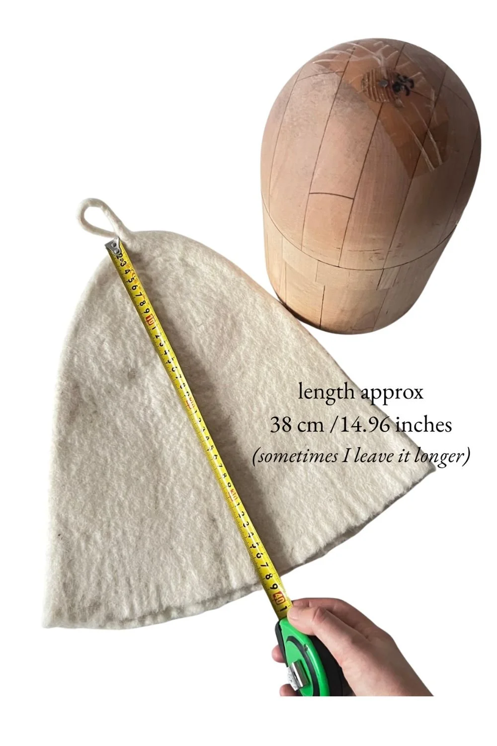 Tall undyed wool sauna hat beside a tape measure showing a height of about 15 in (38 cm)