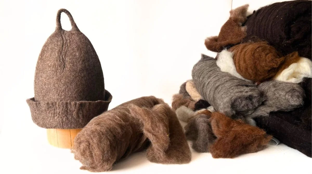 Undyed wool sauna hat hand-sculpted by Dovilė, shown beside the raw Alpine mountain wool it is made from.