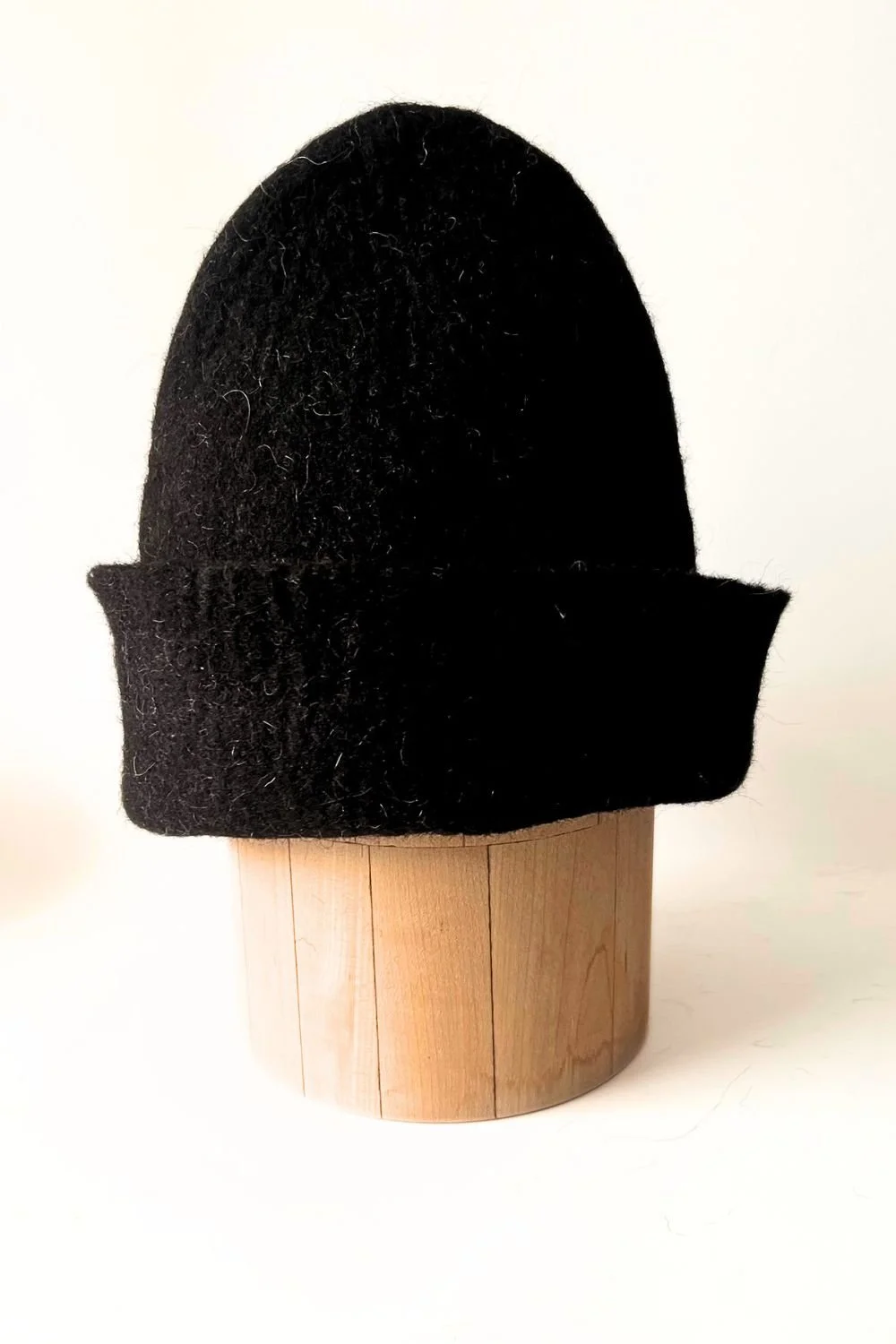 Undyed wool sauna hat without a loop, a clean sculptural shape in natural black, hand-sculpted by FELTFORMA