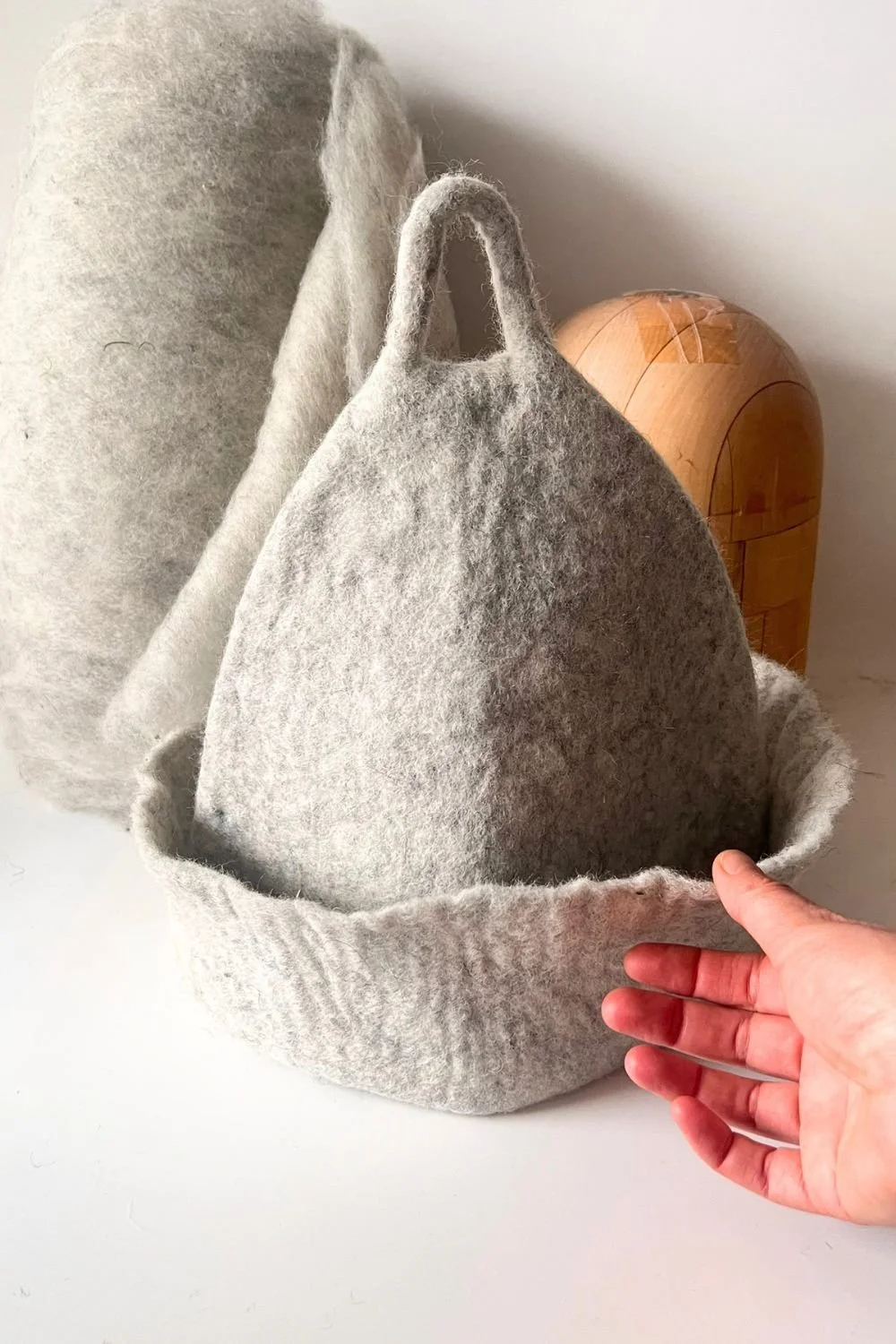 The same wool sauna hat with the brim folded up, sitting higher and lighter