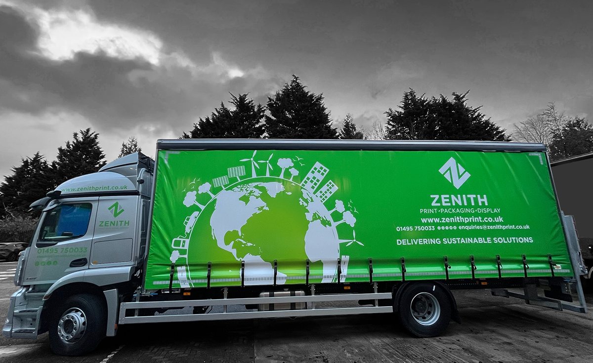 A delivery truck with a bright green side panel displaying the company name 'Zenith' and text promoting sustainable solutions. The panel features a globe graphic with eco-friendly symbols like wind turbines and solar panels. The website and contact details are also visible.