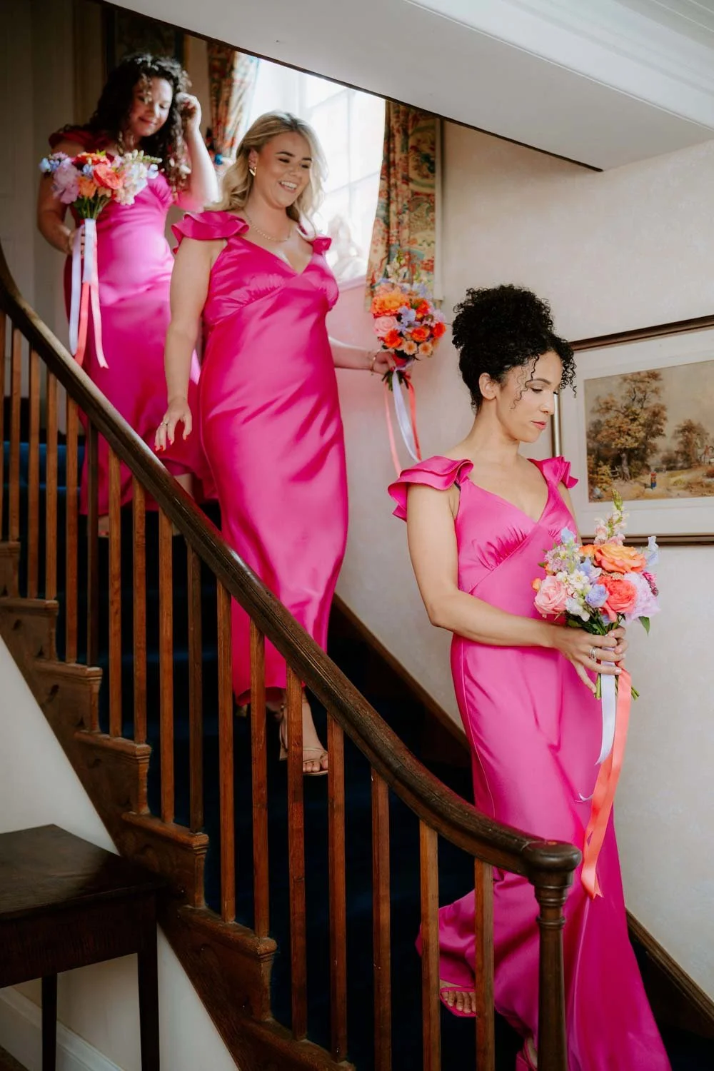 Bridesmaids walking downstairs ready for wedding ceremony.jpg