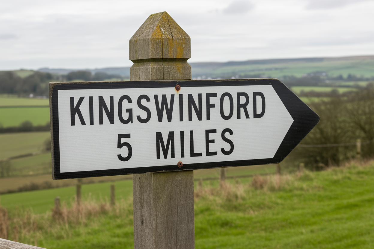 Roadside sign indicating the direction and distance to Kingswinford, 5 miles away, with a rural landscape in the background.