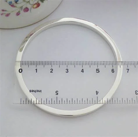 Silver bracelet with ruler measuring diameter