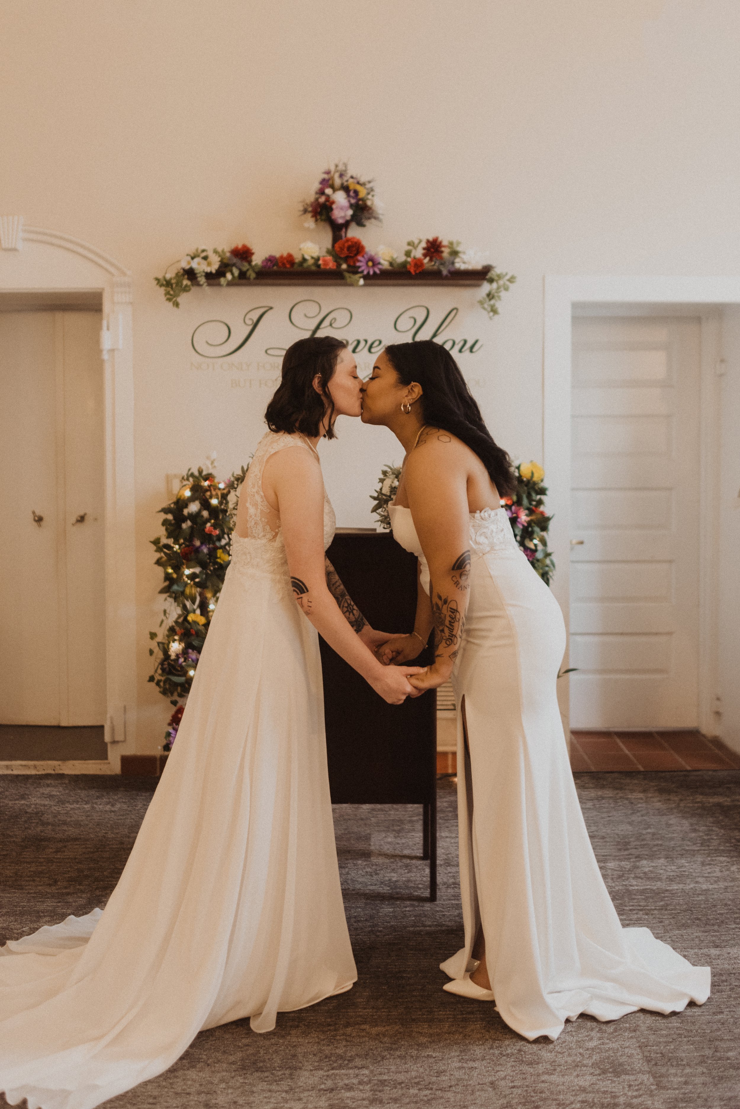 two brides sharing their first kiss as newlyweds