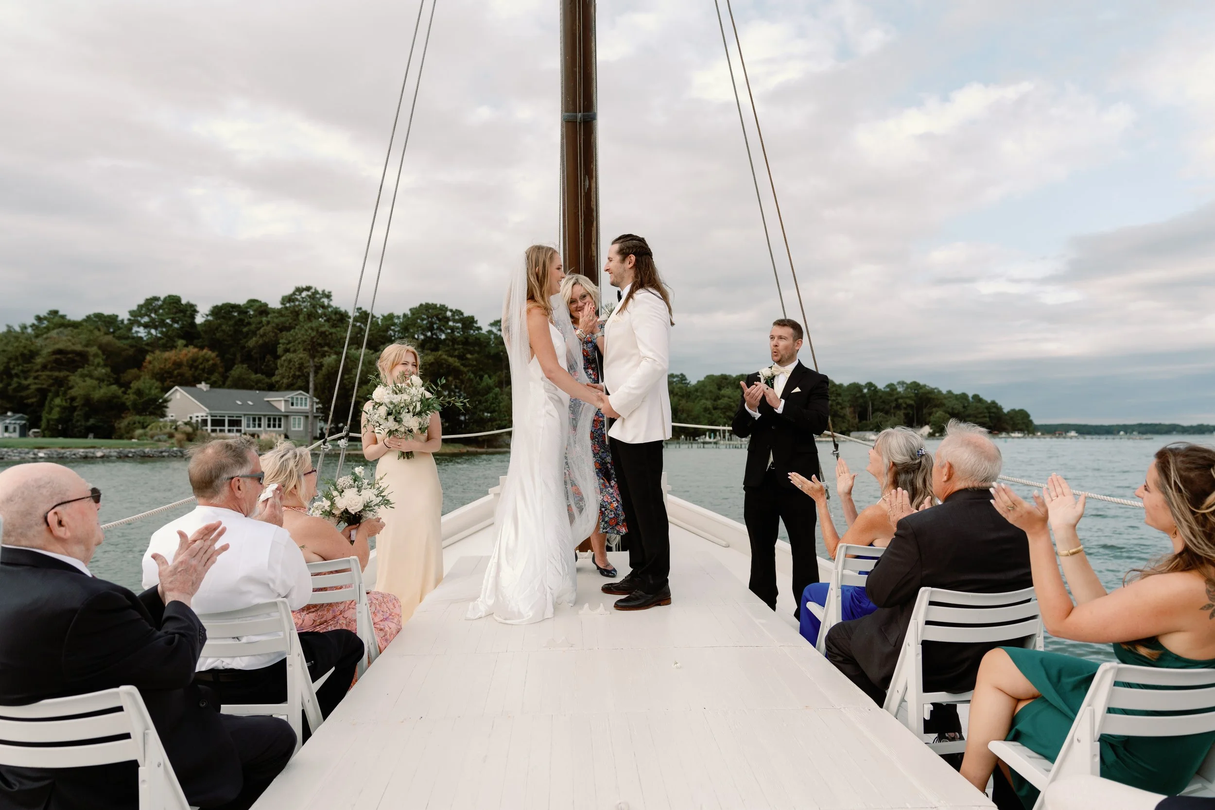 bride and groom getting married on a fishing boat