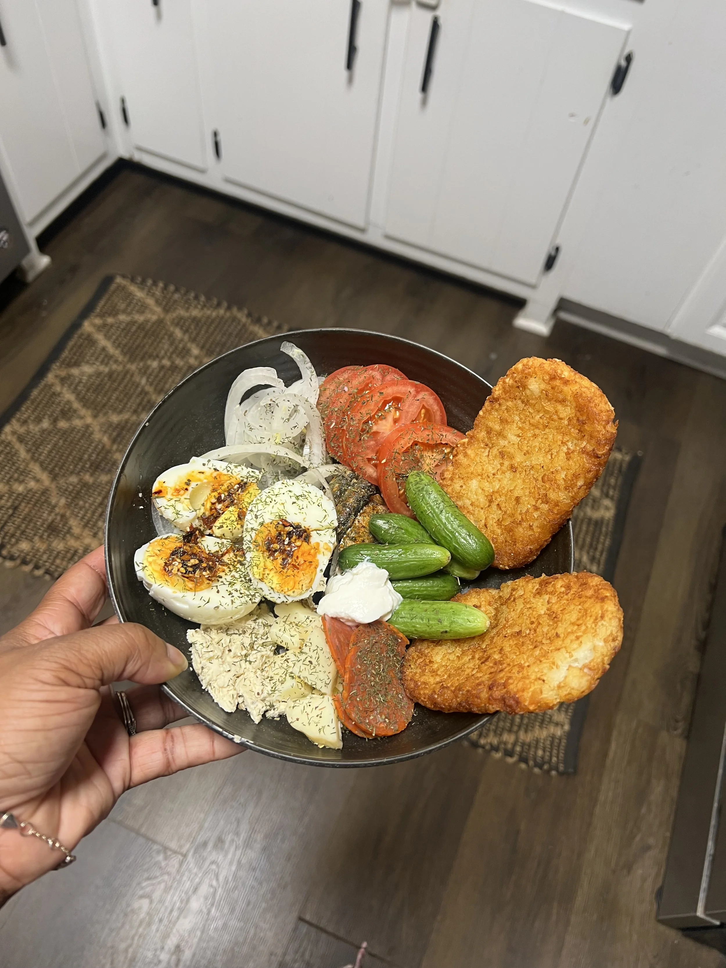 Trending "Salty Girl Plate:" crispy hashbrowns, sardines or smoked salmon, pepperoni, boiled eggs with chili oil, mozzarella cheese, tomatoes, onions, cucumbers, greek yogurt, dill seasoning