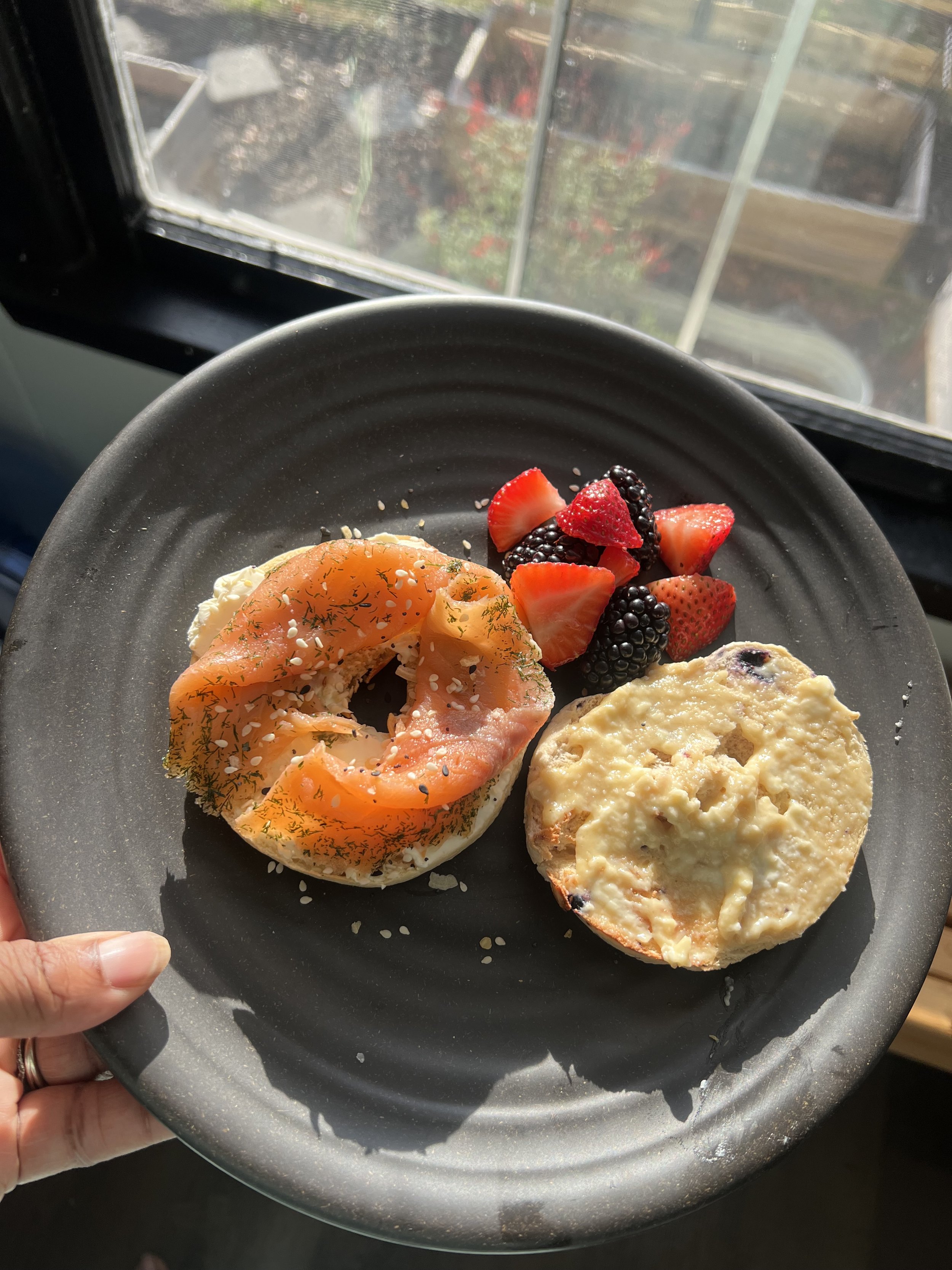 1/2 smoked lox salmon with plain cream cheese and everything seasoning, 1/2 blueberry bagel with honey cream cheese, strawberry and blackberry mix