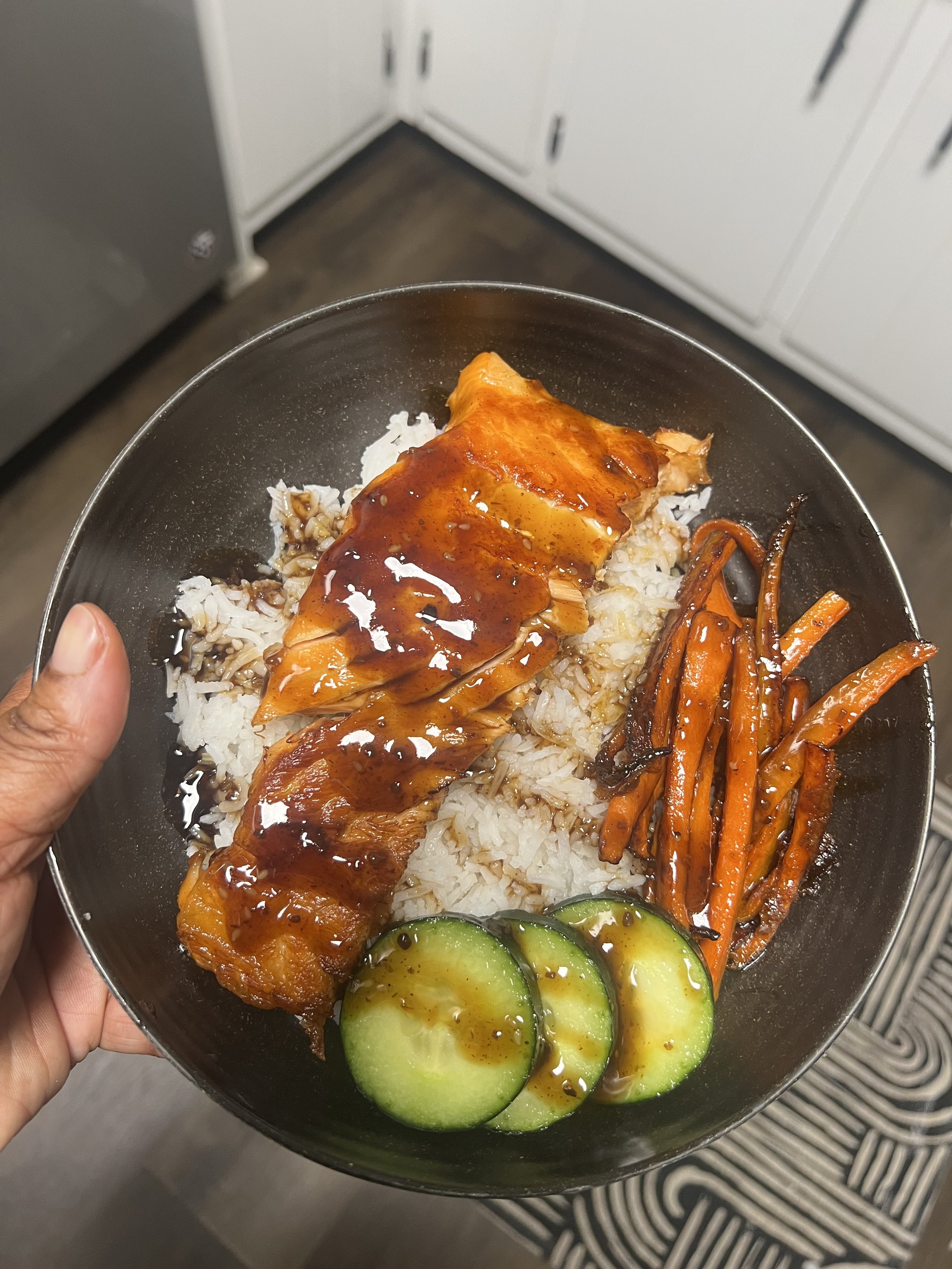 Seared smoked salmon, basmati rice, glazed carrots, and cucumbers with teriyaki sauce