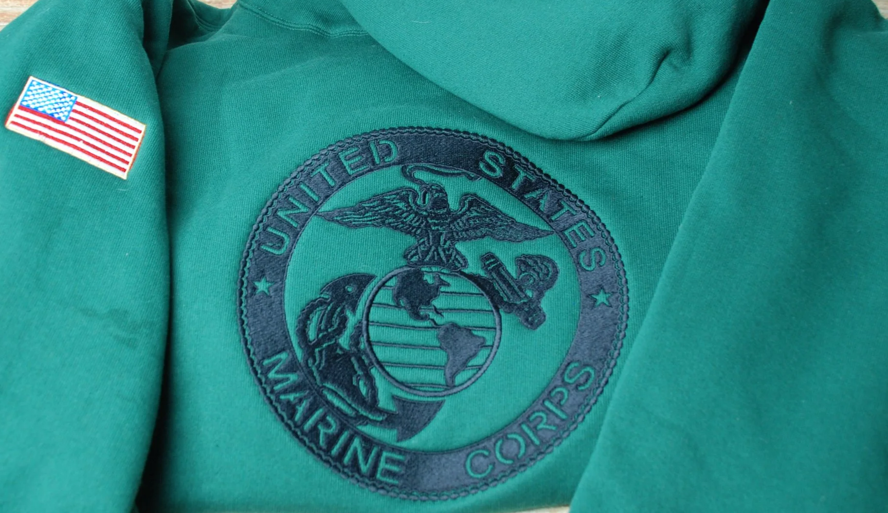 green hooded sweatshirt with USMC globe and anchor embroidered and American flag on sleeve