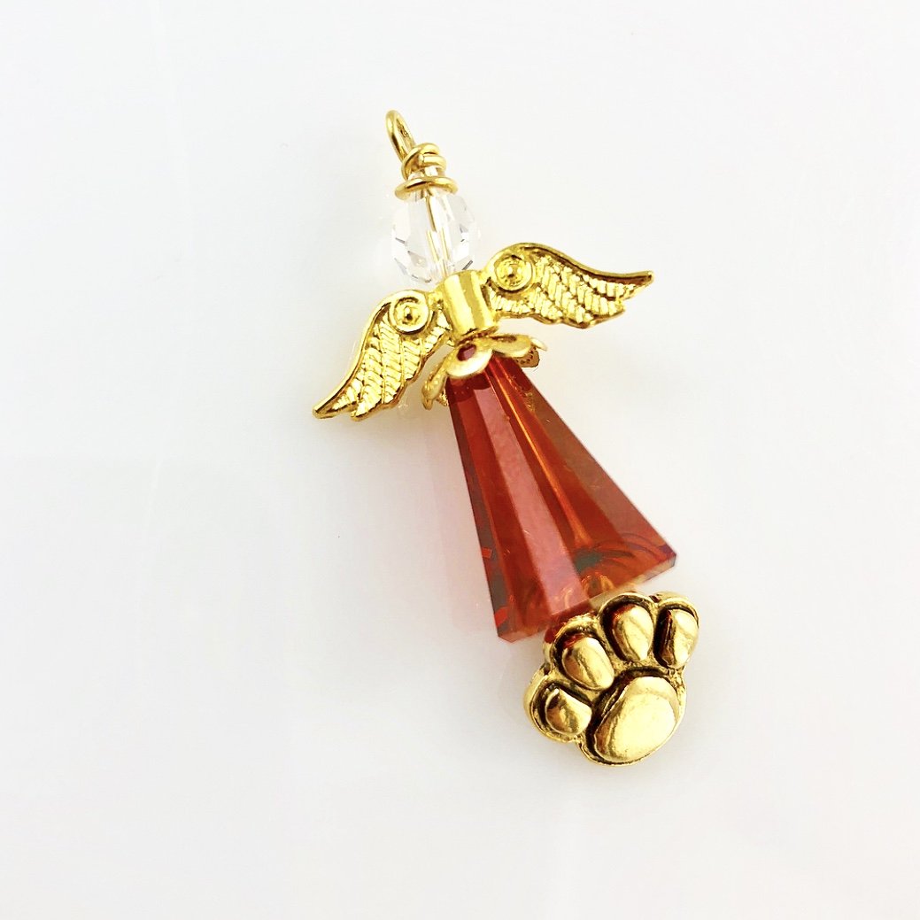 Large red angel with golden paw to pay tribute to a much loved pet friend