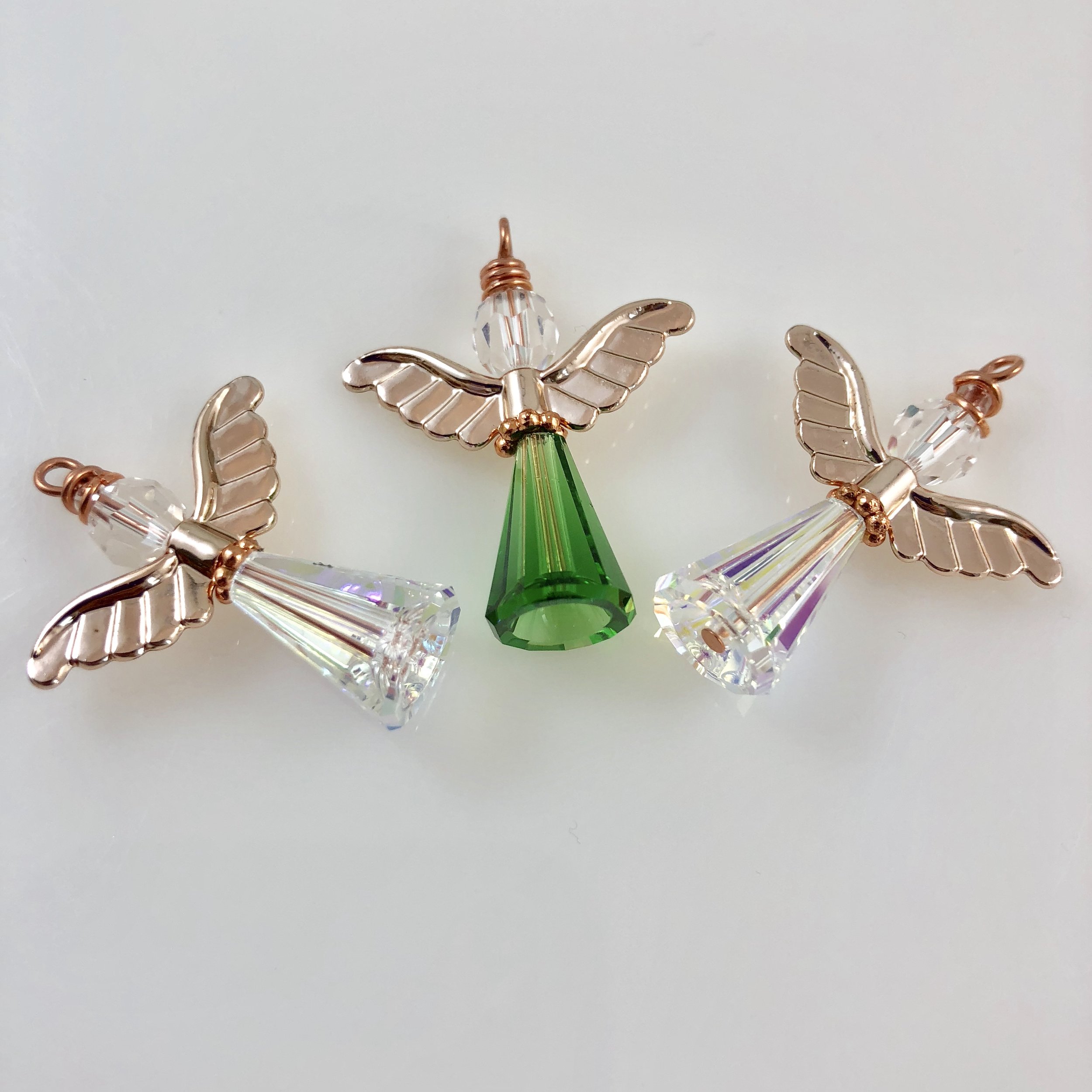 Small iridescent and green angels with rose gold wings